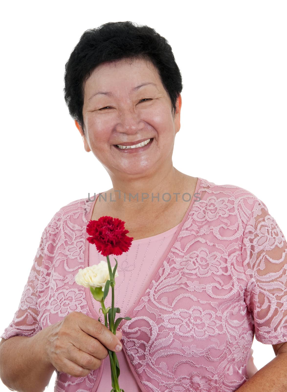 Happy Asian grandmother with carnation flowers on white background
