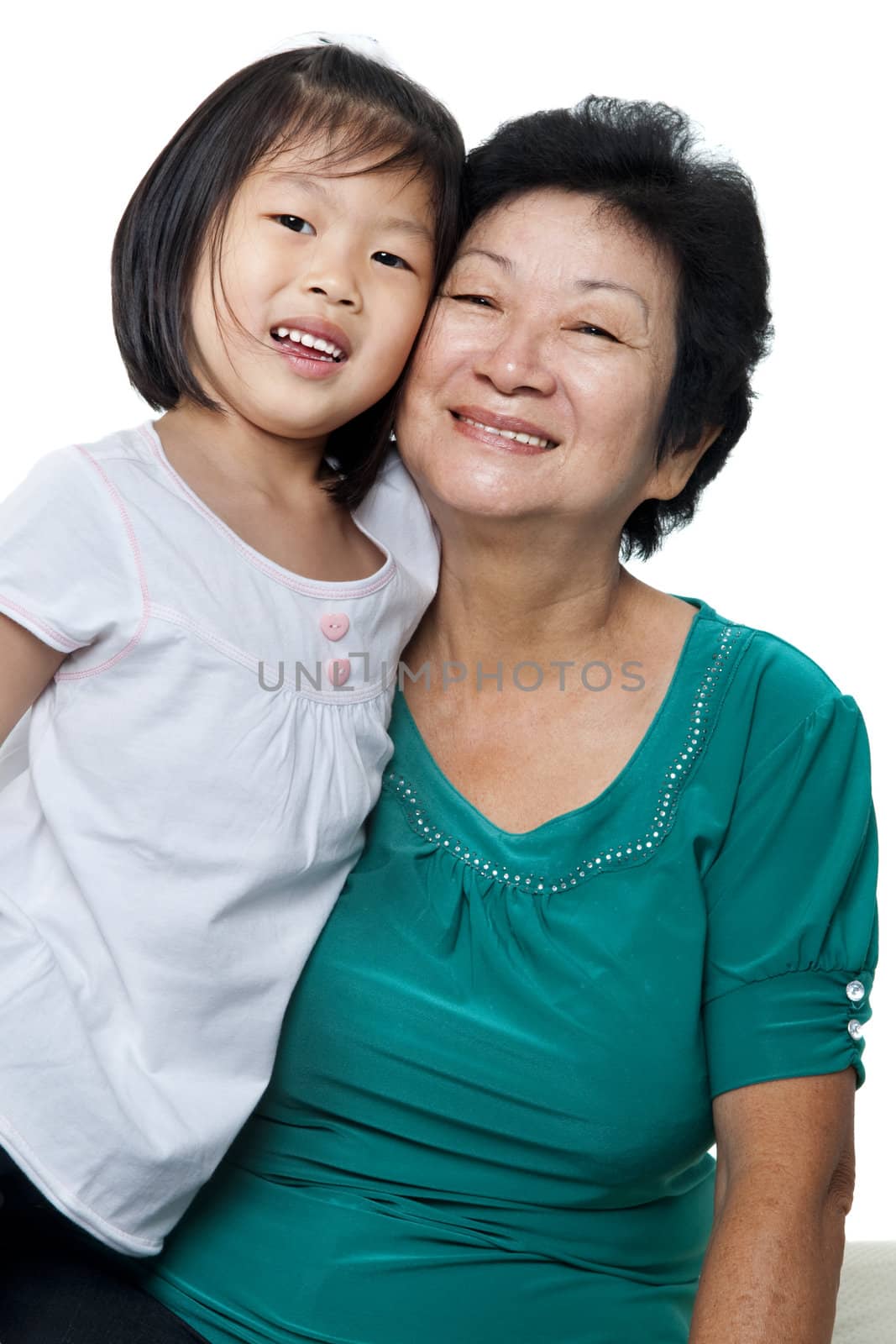 Photo of Asian grandmother and granddaughter on white background.