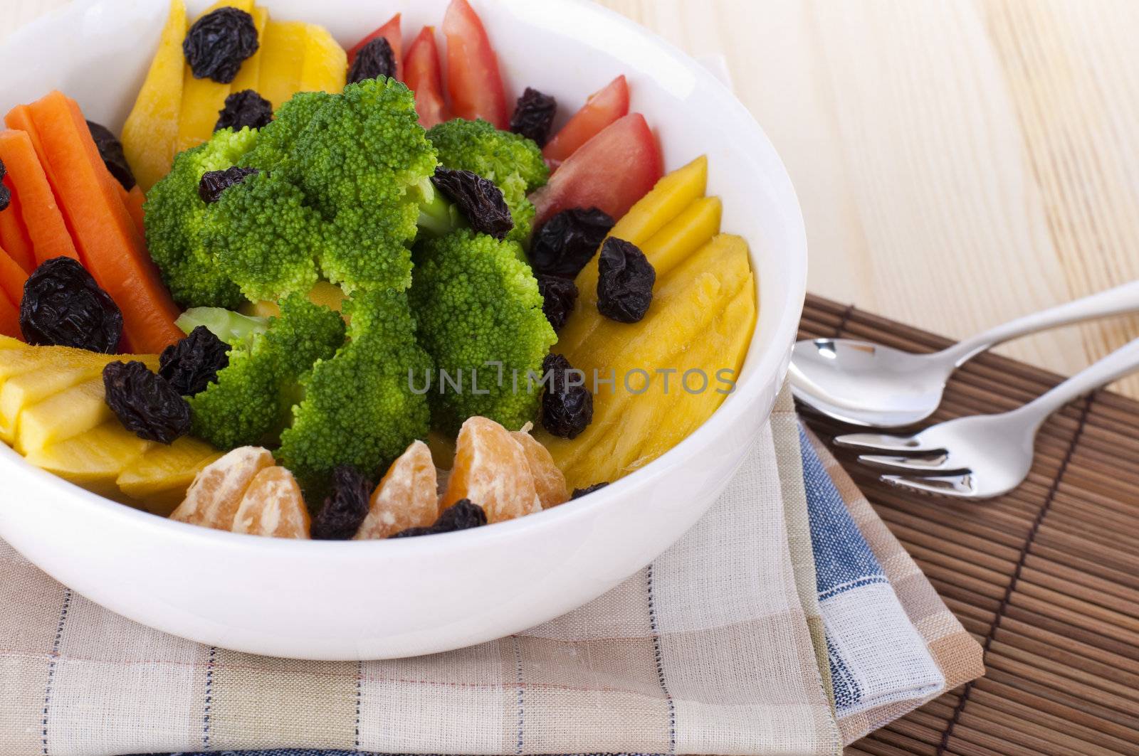 Close up fresh fruit and vegetable salad.