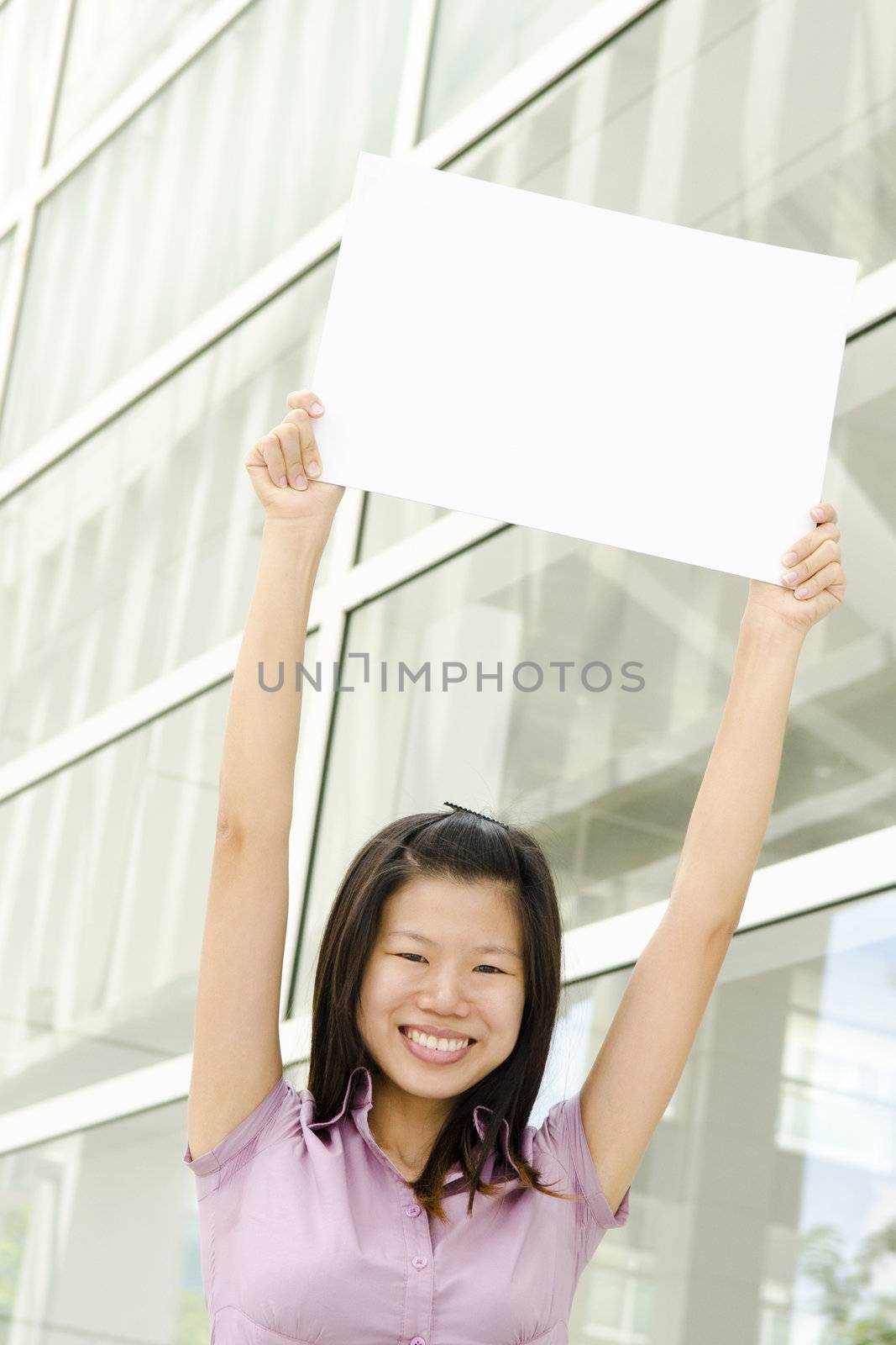 Beautiful businesswoman with blank paper for advertisement