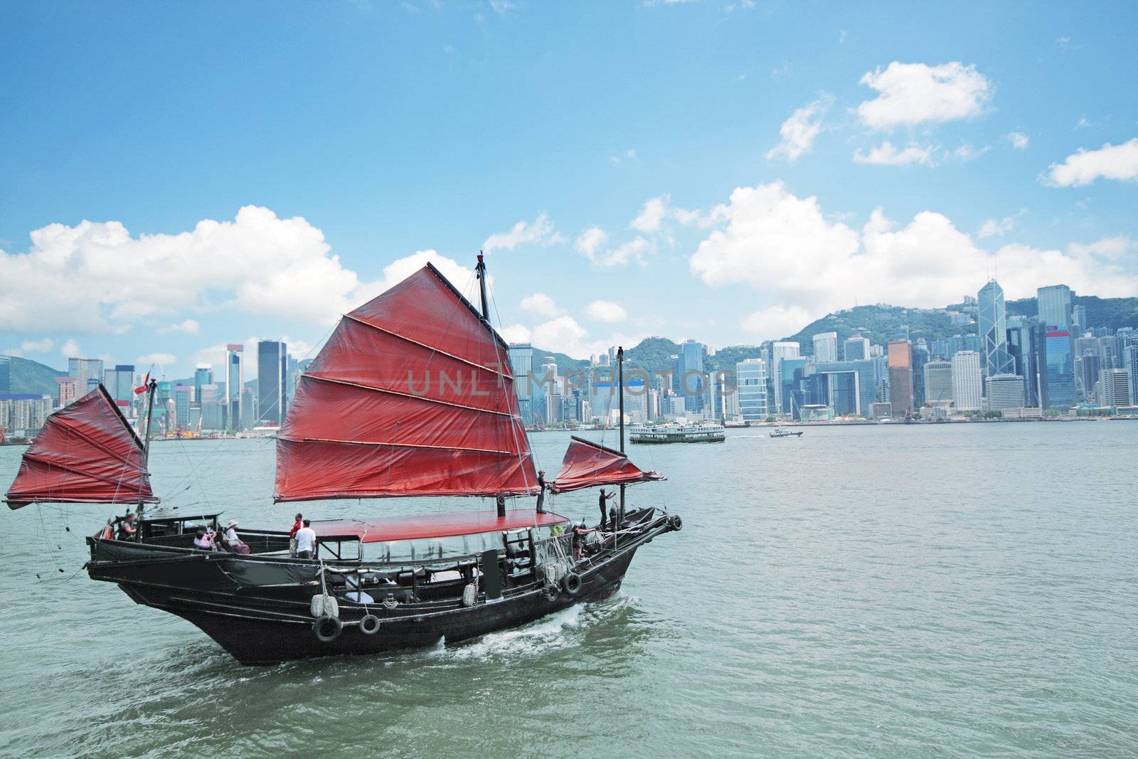 Junk boat with tourists in Hong Kong Victoria Harbour
