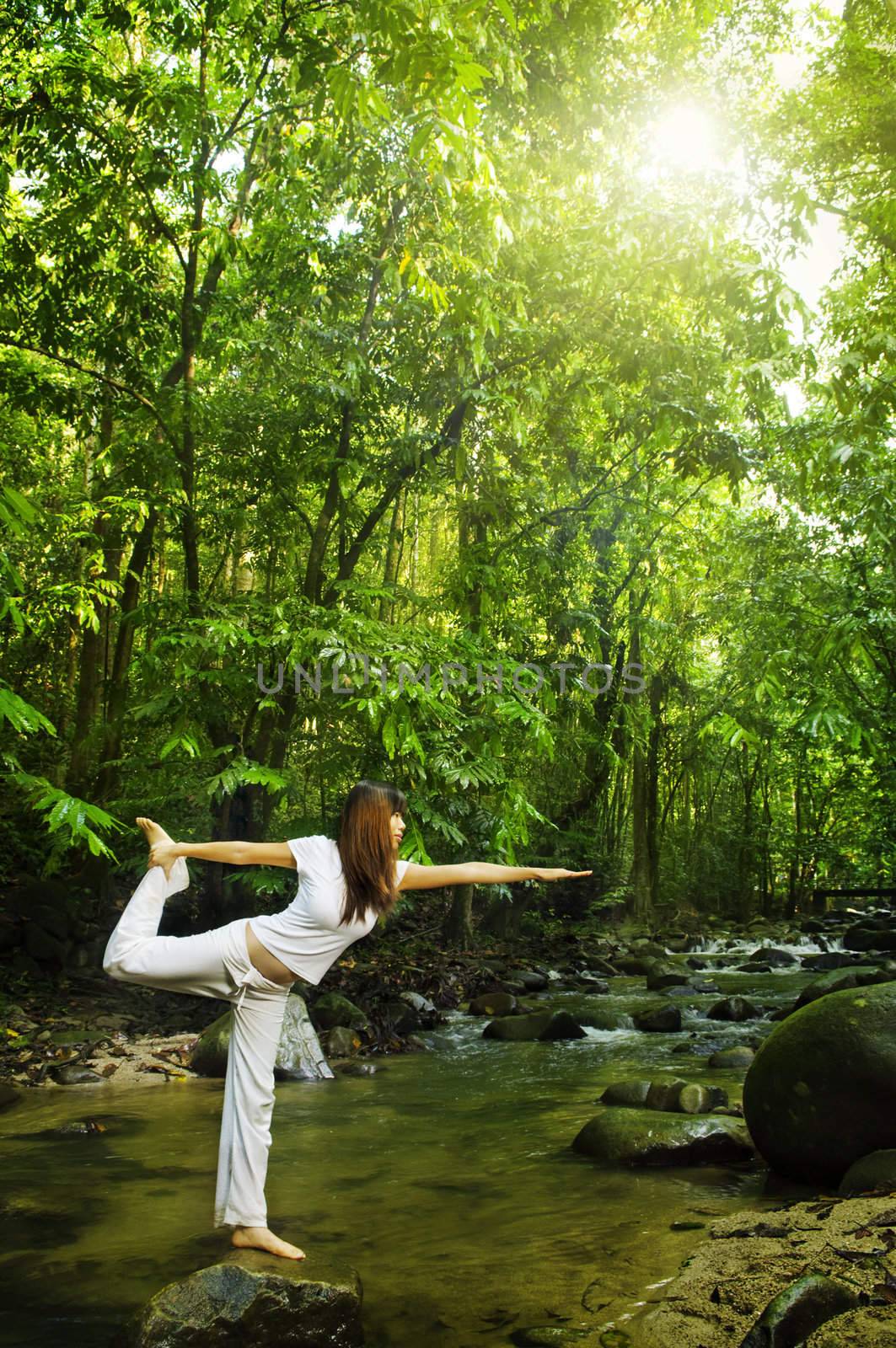 Female practises balancing at  nature tropical forest in a morning.