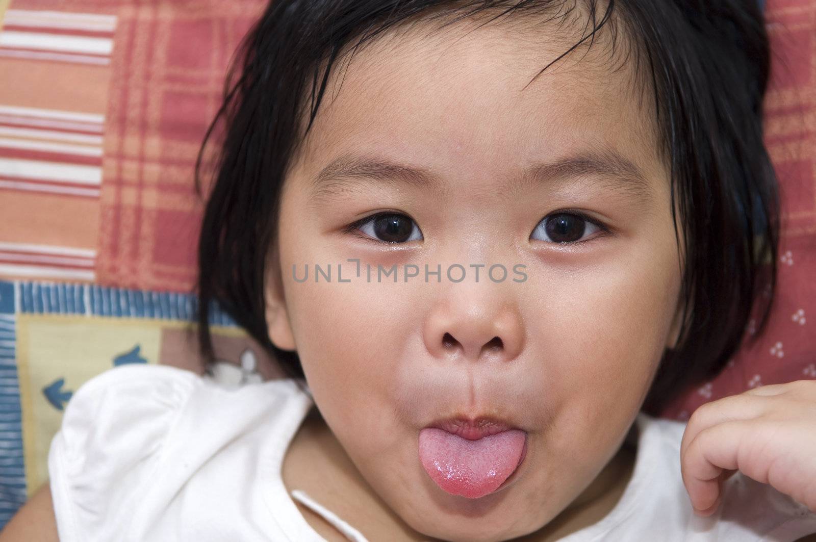 tongue out playful Asian girl 
