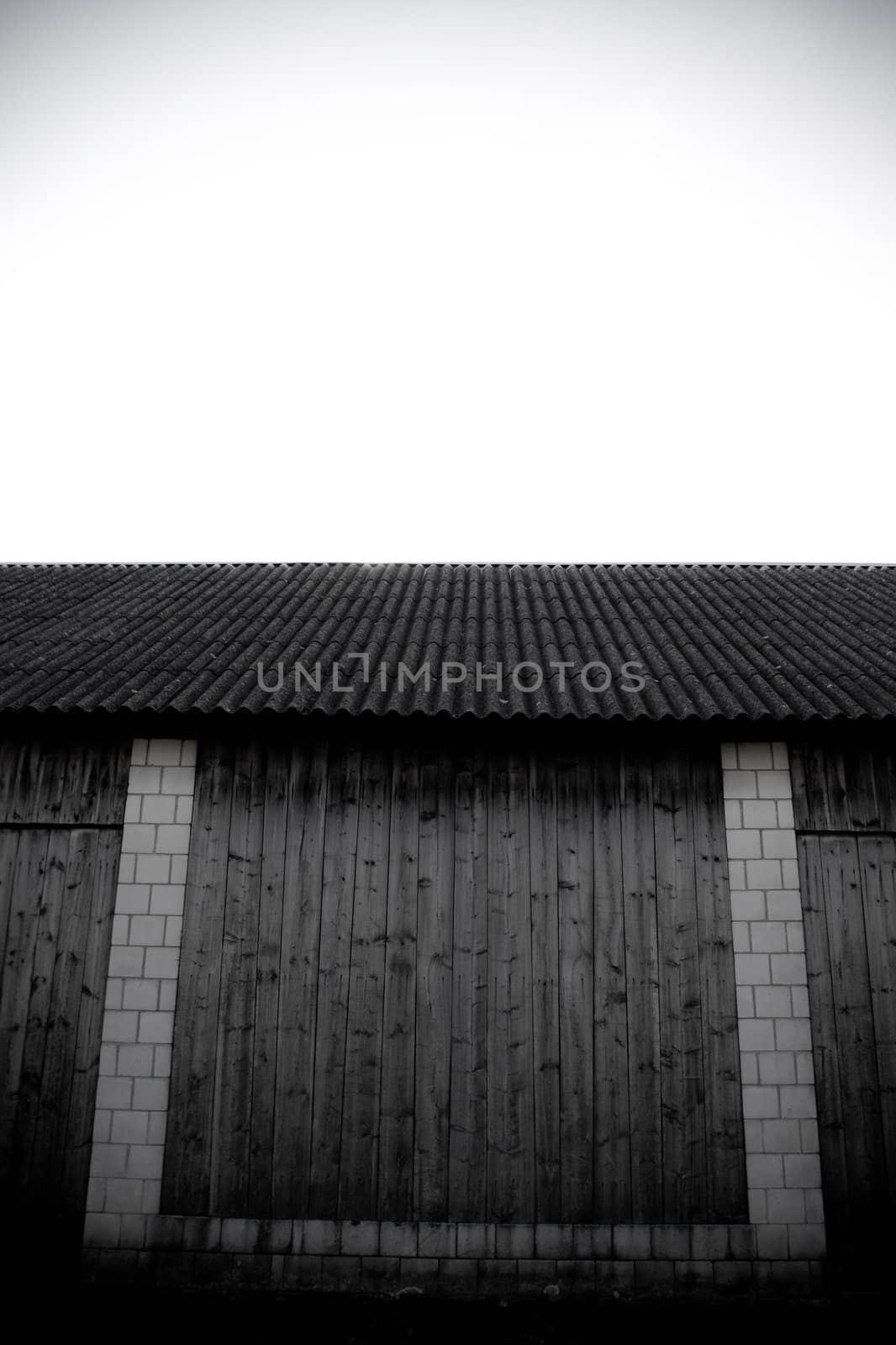 detail of vintage barn made of wood and white stone