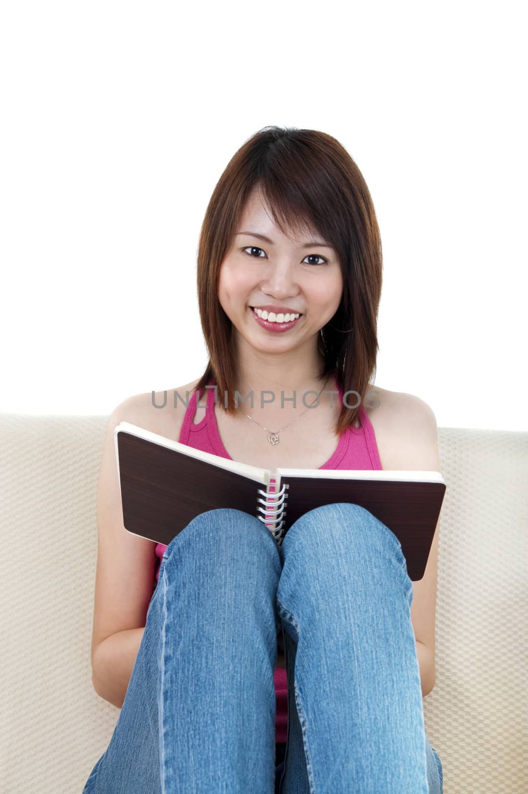 Young Women Reading a Book on Sofa