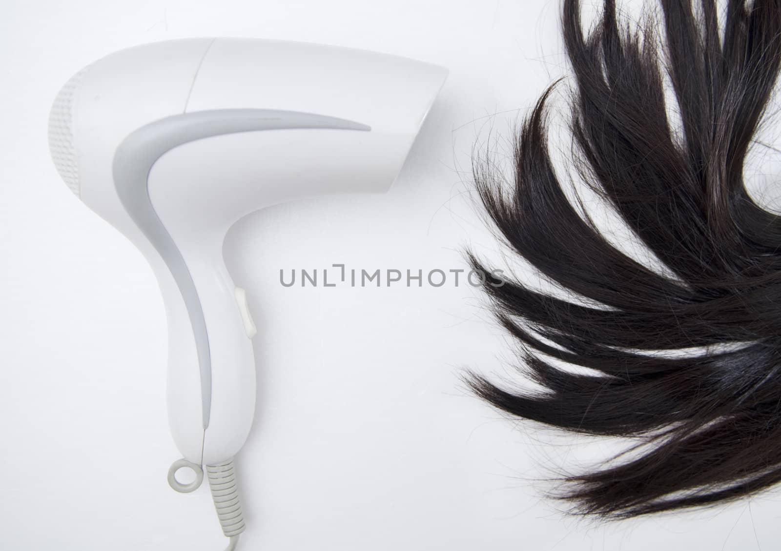 Hair Dryer blowing on woman hair.