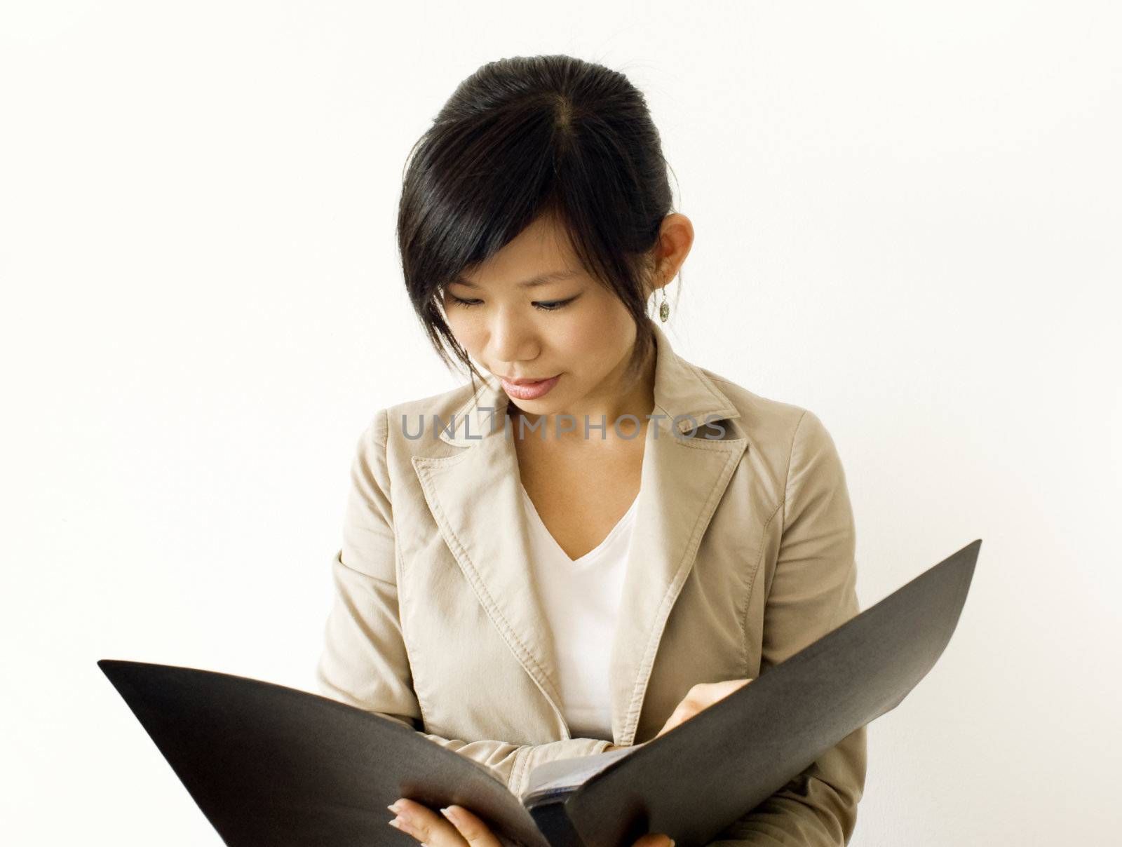Asian girl reading document. For education/business purpose.