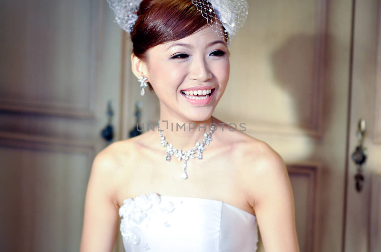 Beautiful Asian bride is smiling.