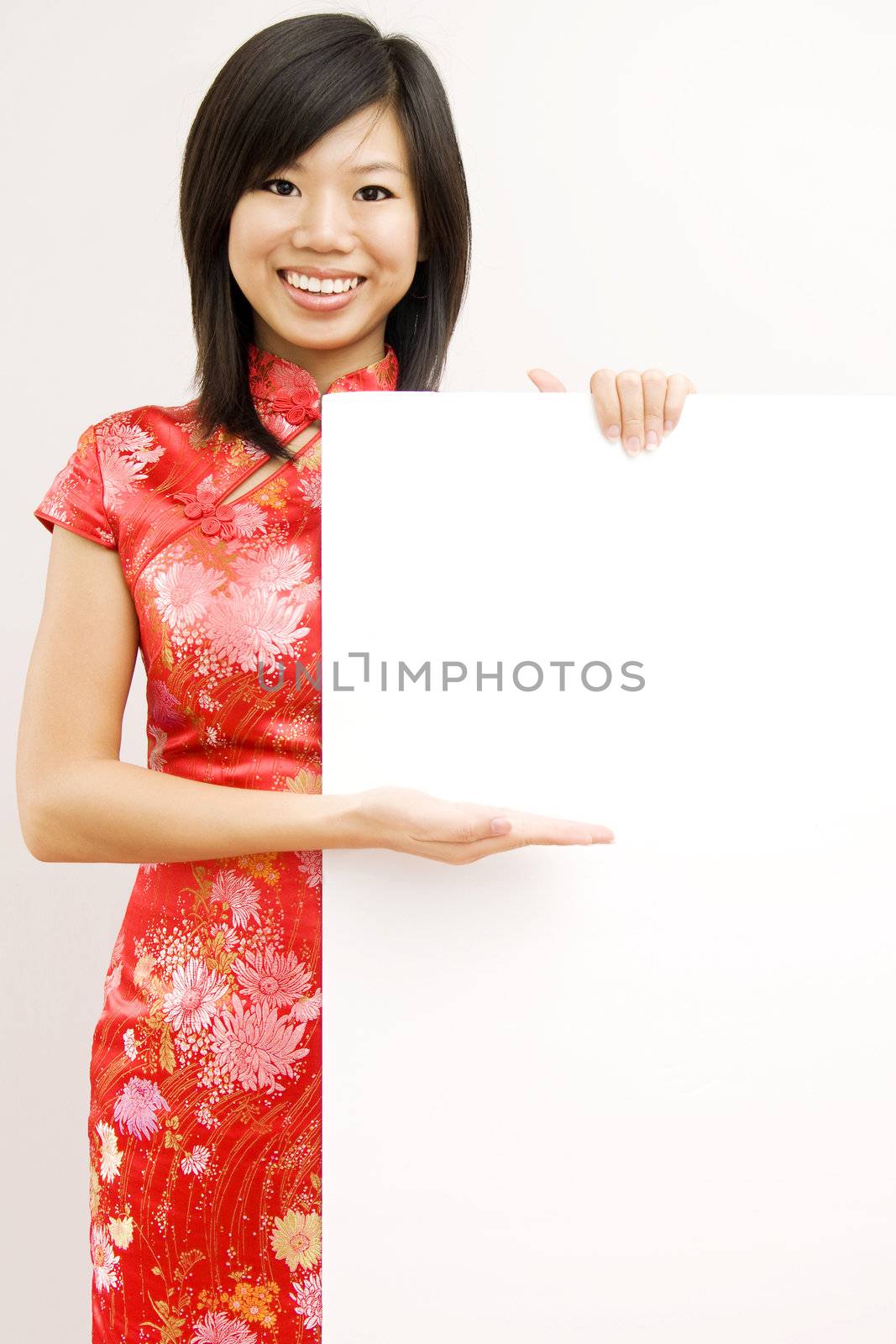 Oriental girl wishing you a happy chinese new year, with copy space. 