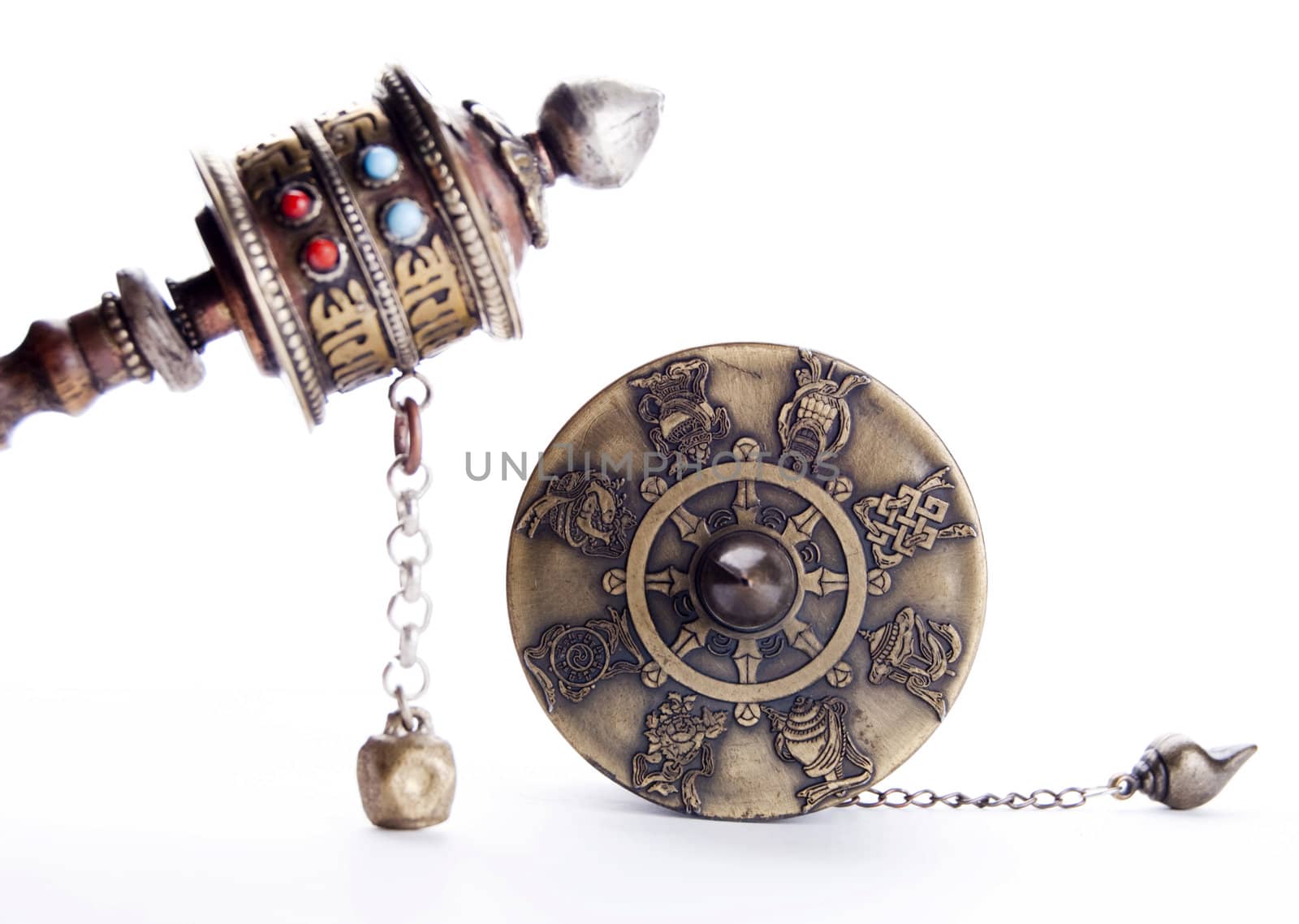 Tibetan portable prayer mills isolated on a white background.