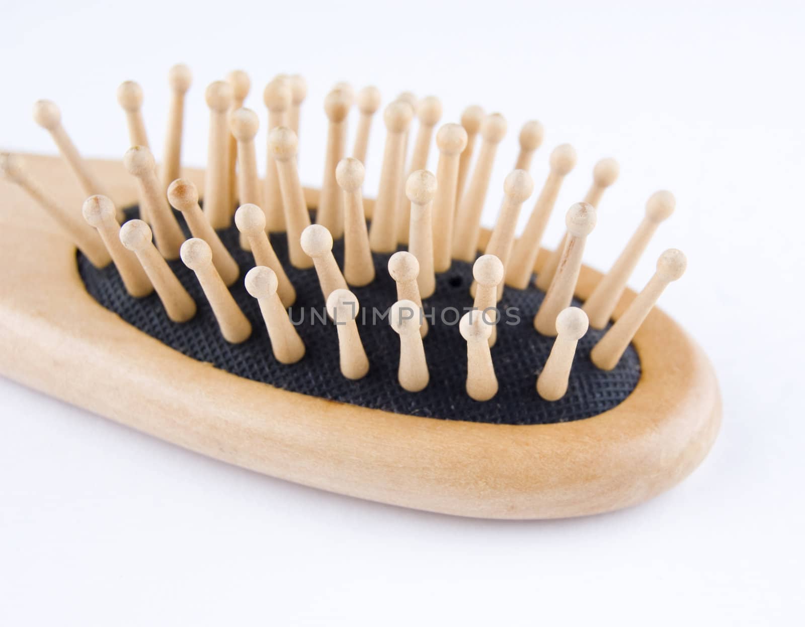 Wooden comb for hair on plain background.