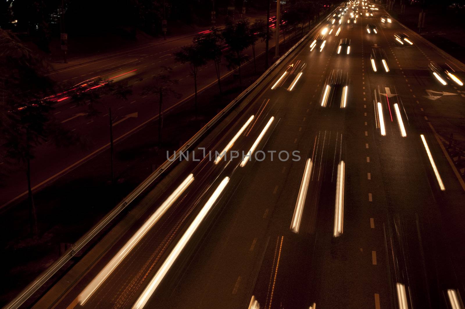Cars moving on busy roads at night.