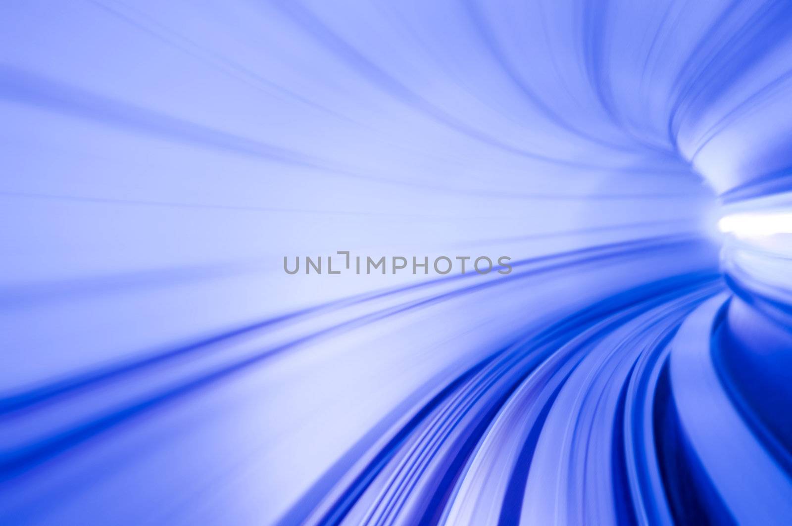 Photo looking in front of an airport train inside tunnel.