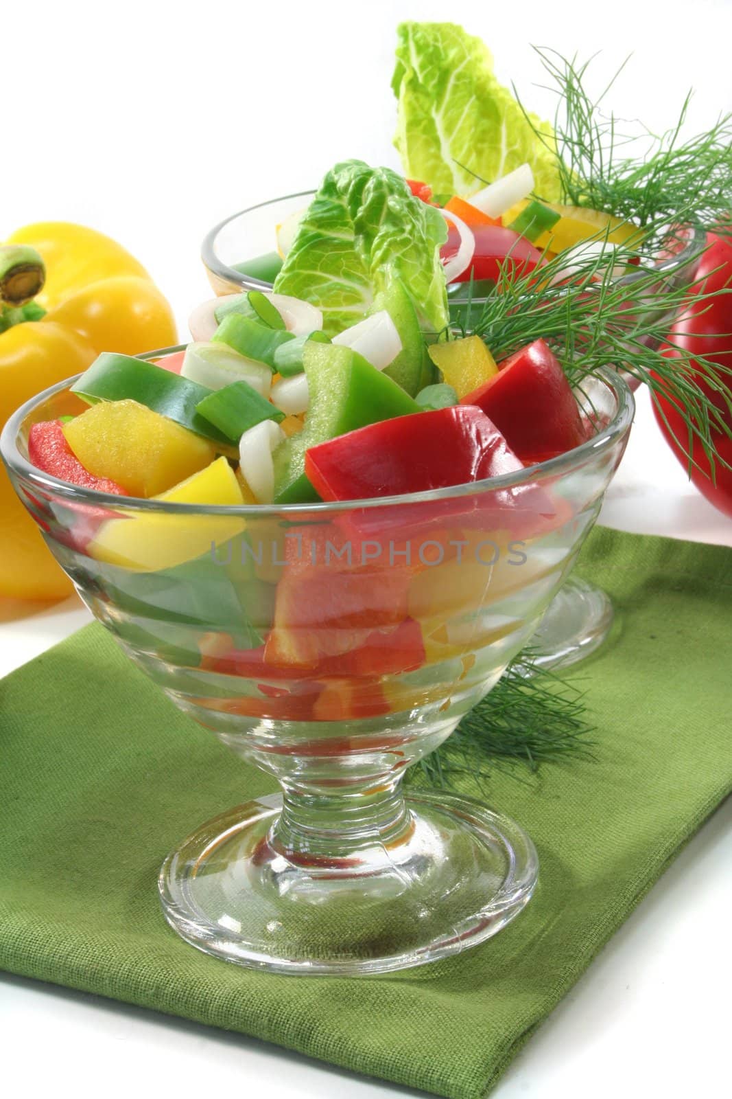 colorful bell pepper salad with dill in small glass bowl