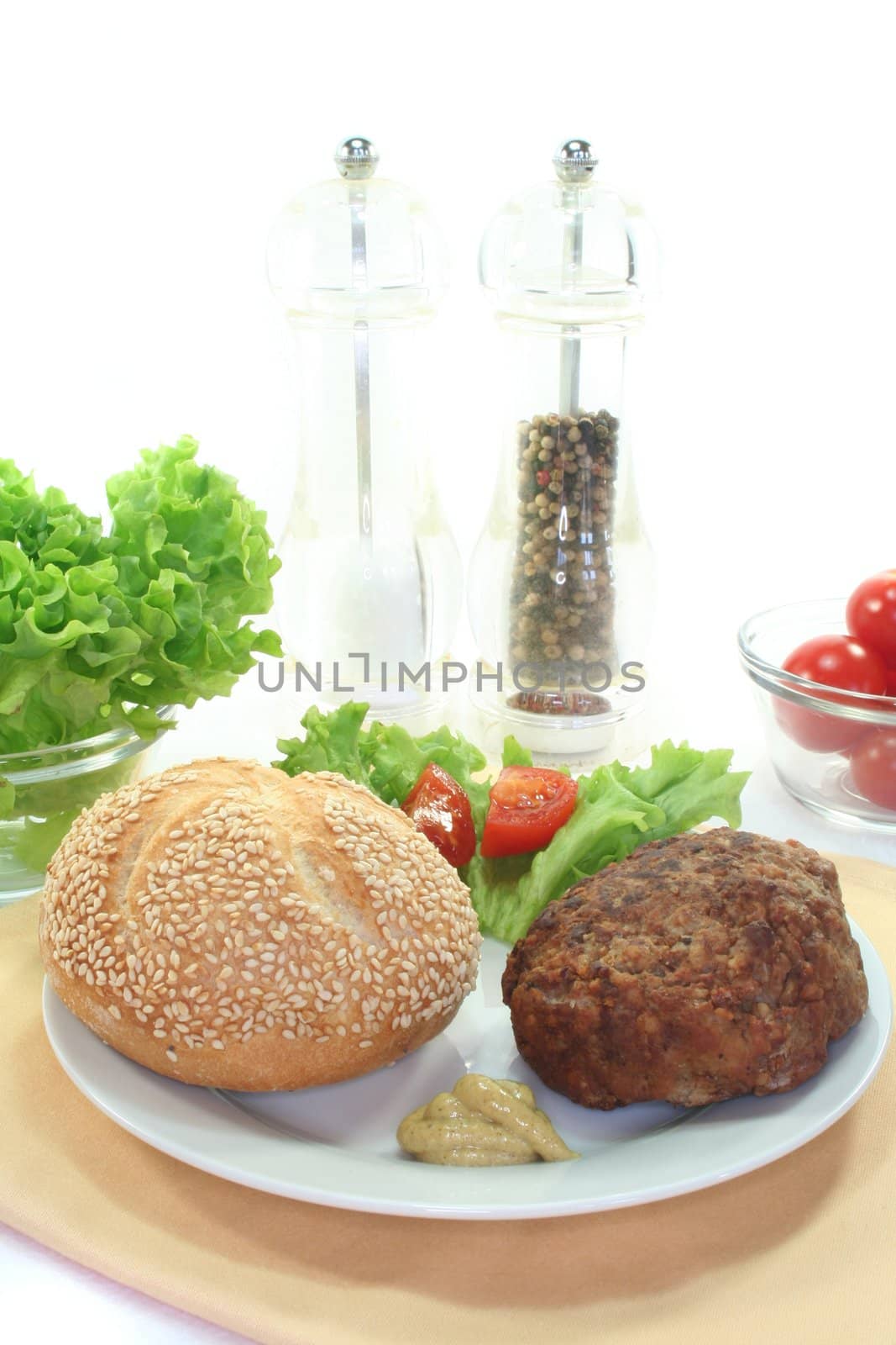 meatball with bun, fresh lettuce and tomato pieces