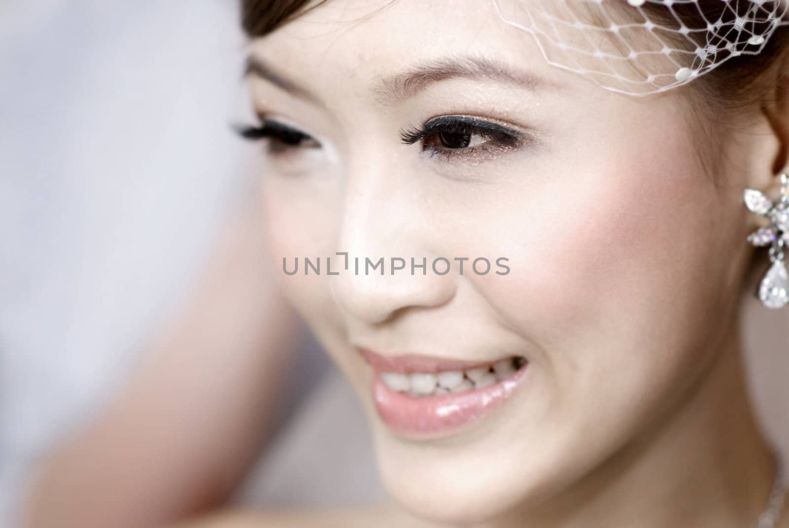 Beautiful young Asian bride smiling.