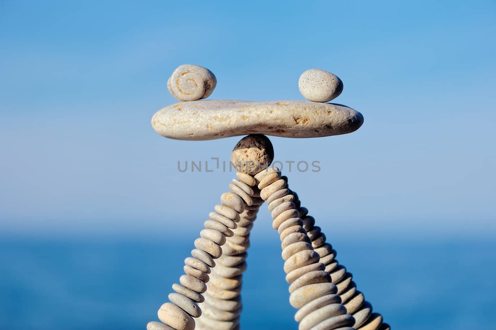 Balancing of white stones on the top of pyramidal stack