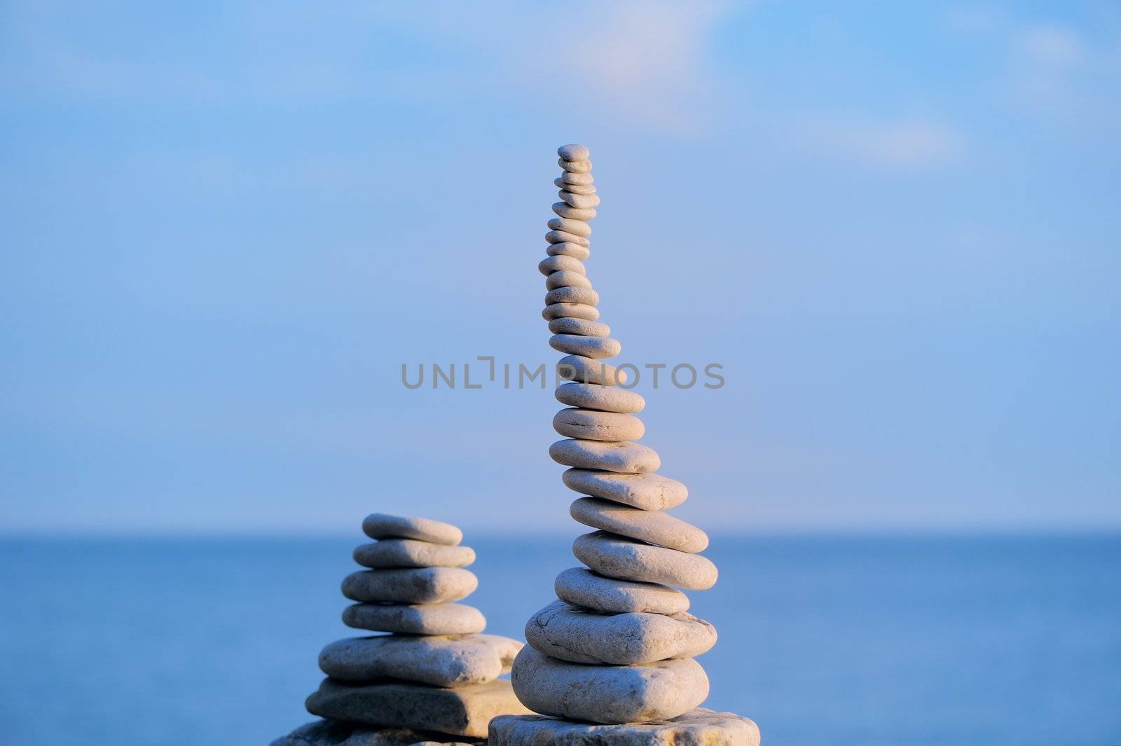 Pile of small pebbles in the balance on the seacoast