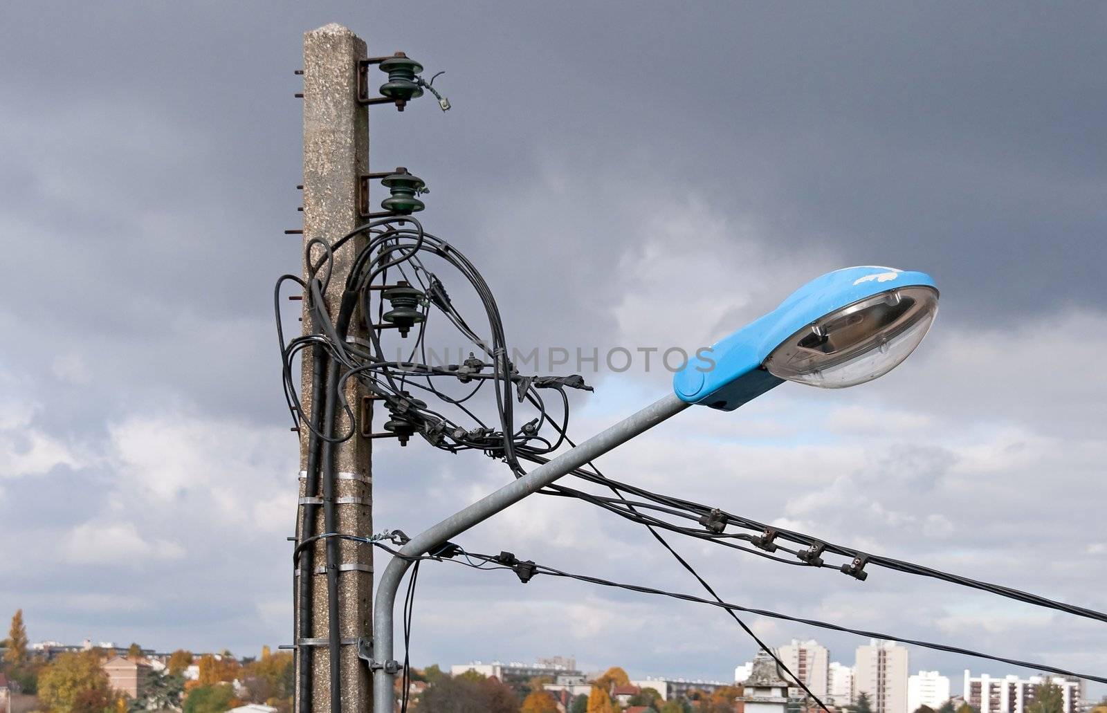 electric light pole, in the background the city