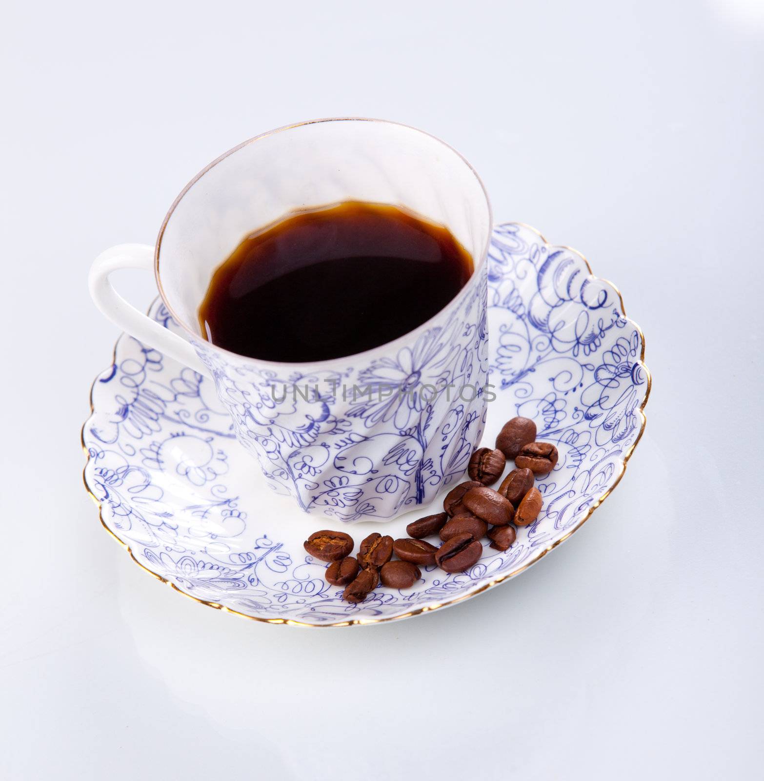 close up of a coffee cup with coffe beans