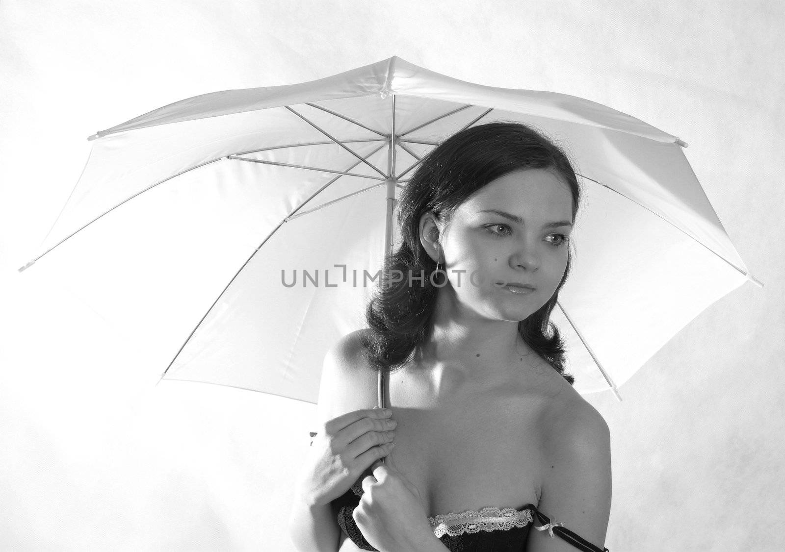 Portrait of the beautiful girl in studio with a umbrella