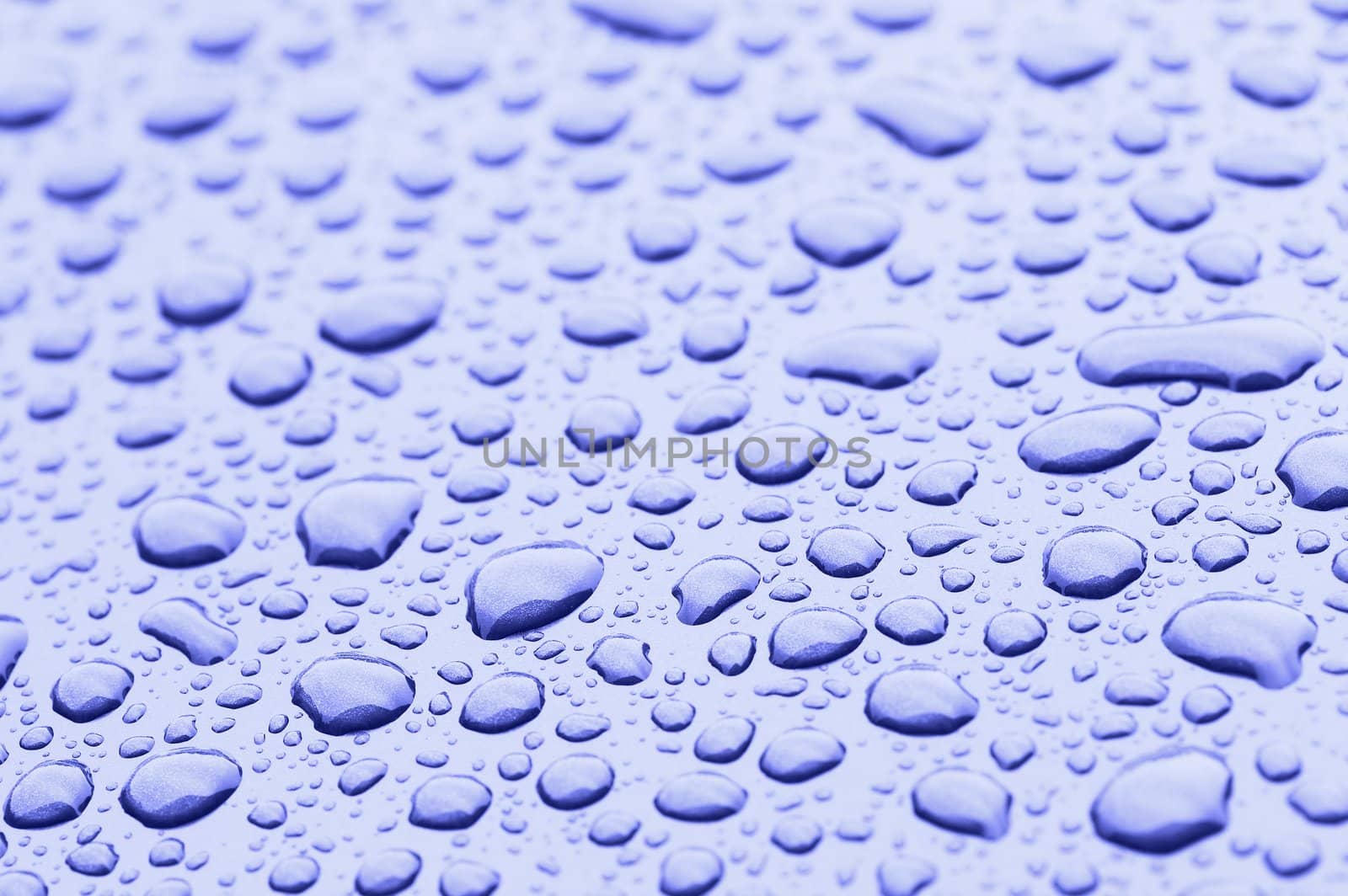 a picture of water drops on metal surface