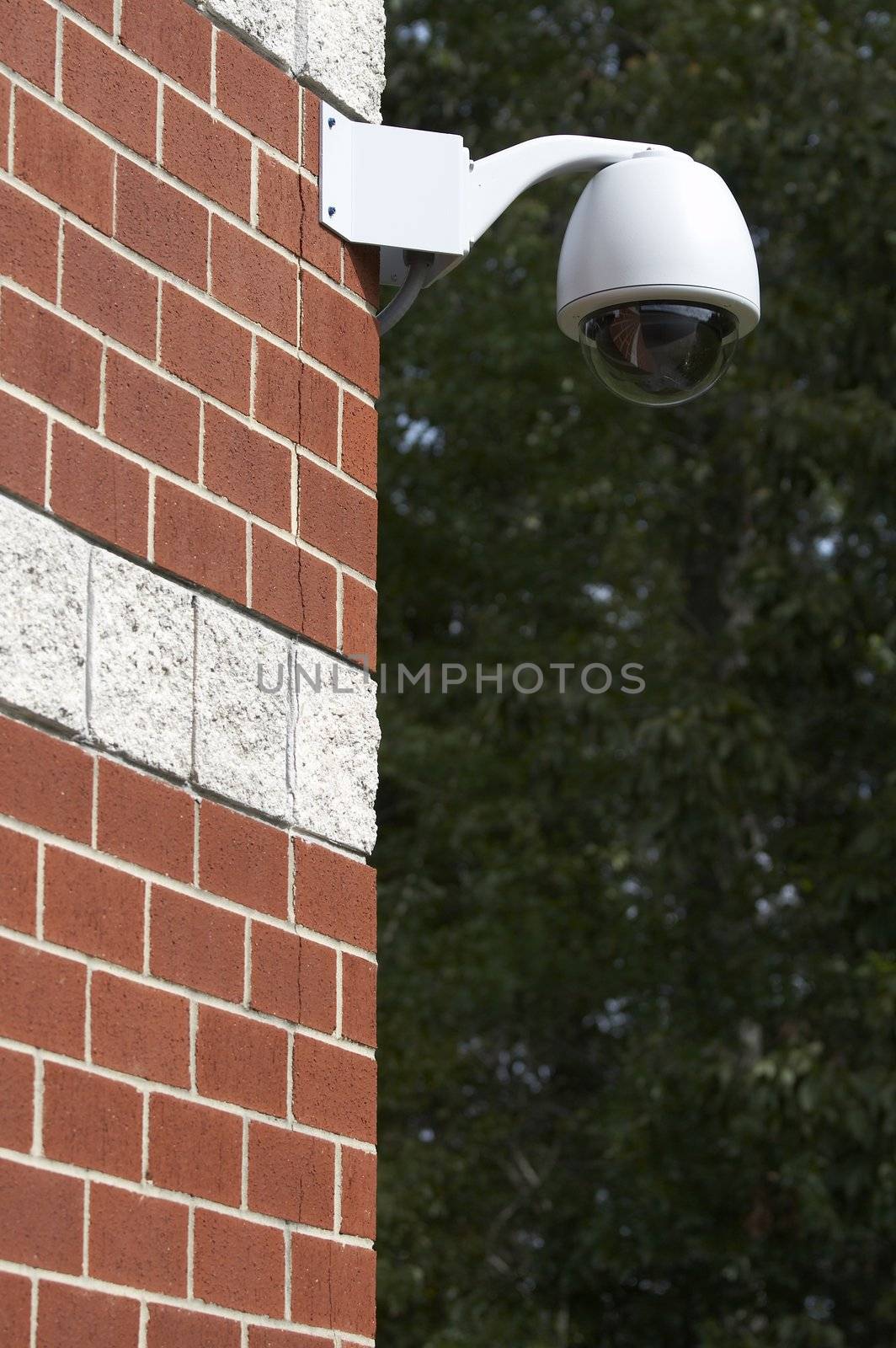 a picture of a surveillance camera on a brick wall