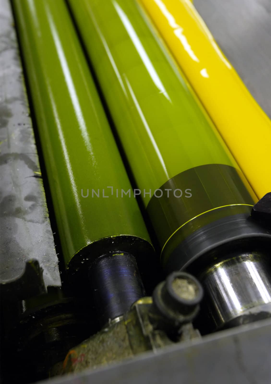 Images of cyan ink in the fountains and on the rollers of a four colour printing press.
