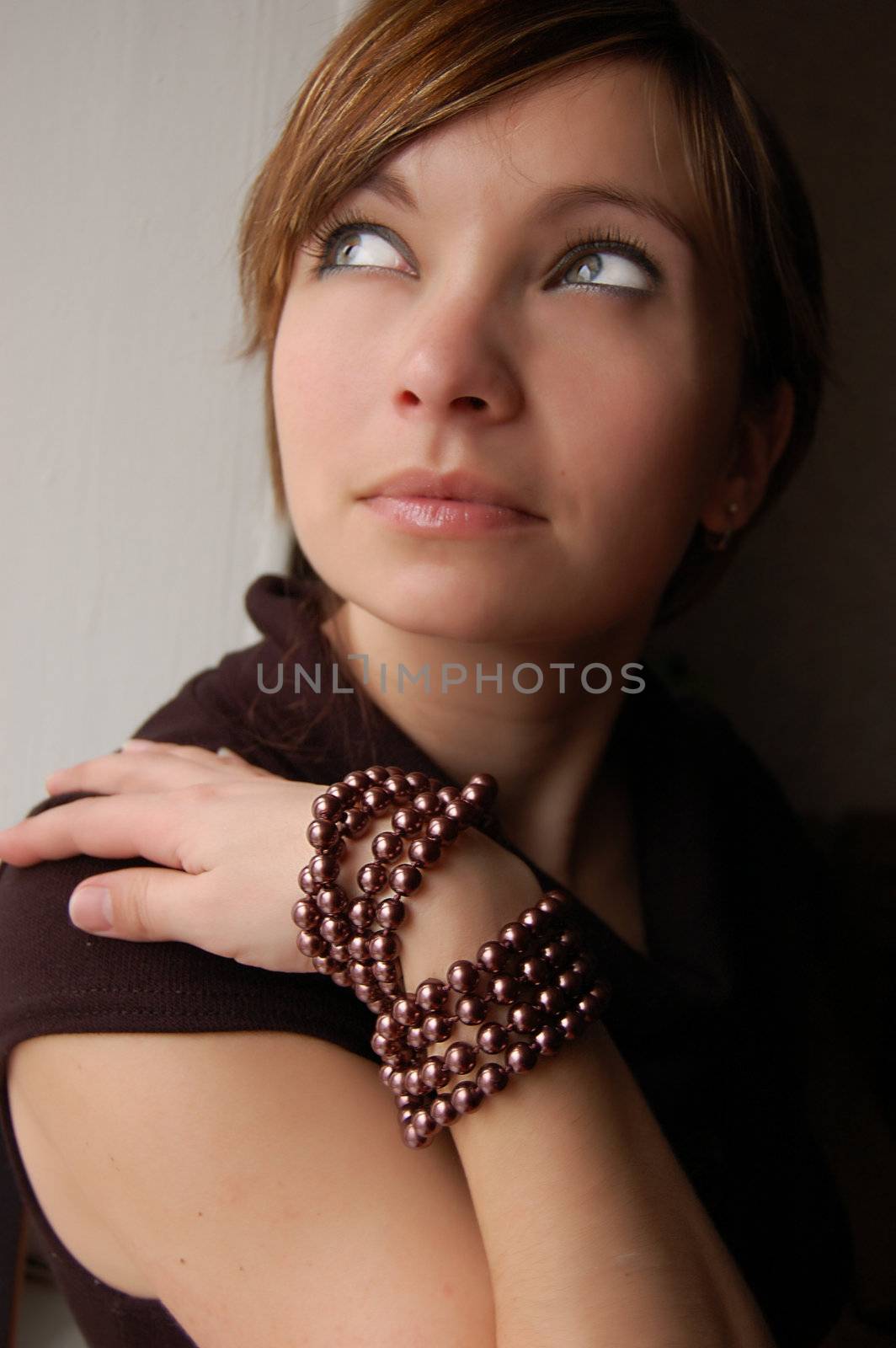 Girl with bracelet looking up