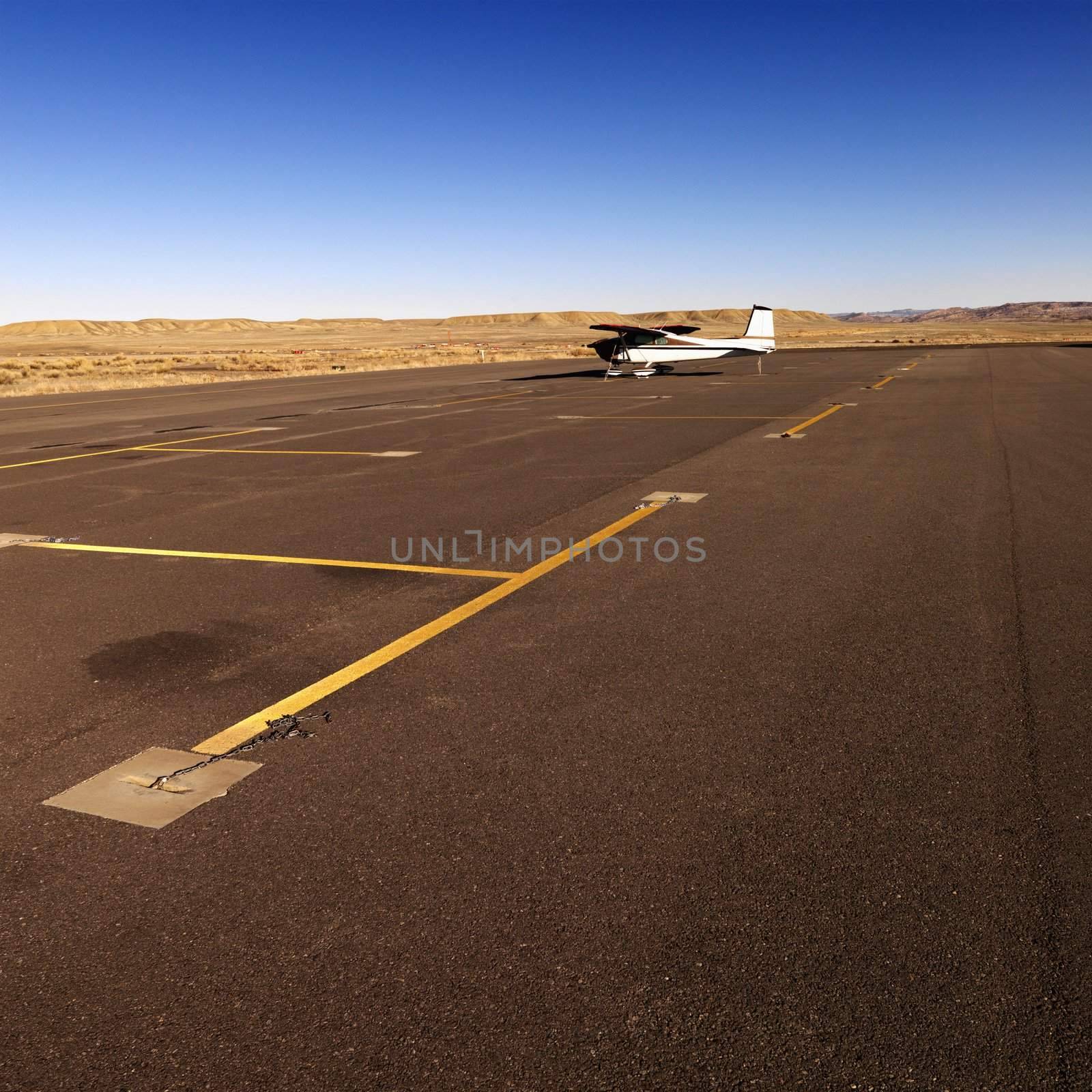 Small plane on tarmac at airport. by iofoto