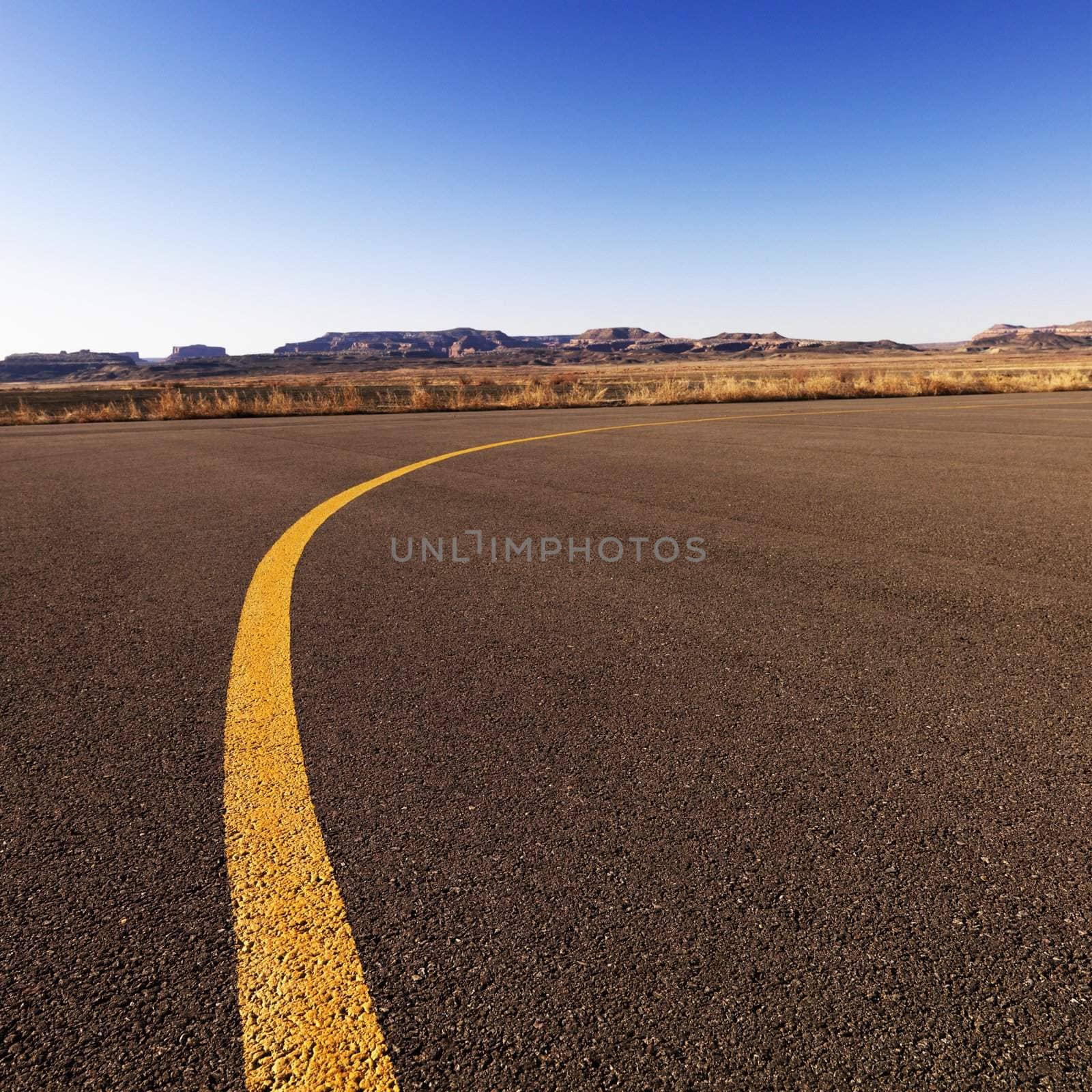 Yellow line on airport tarmac. by iofoto