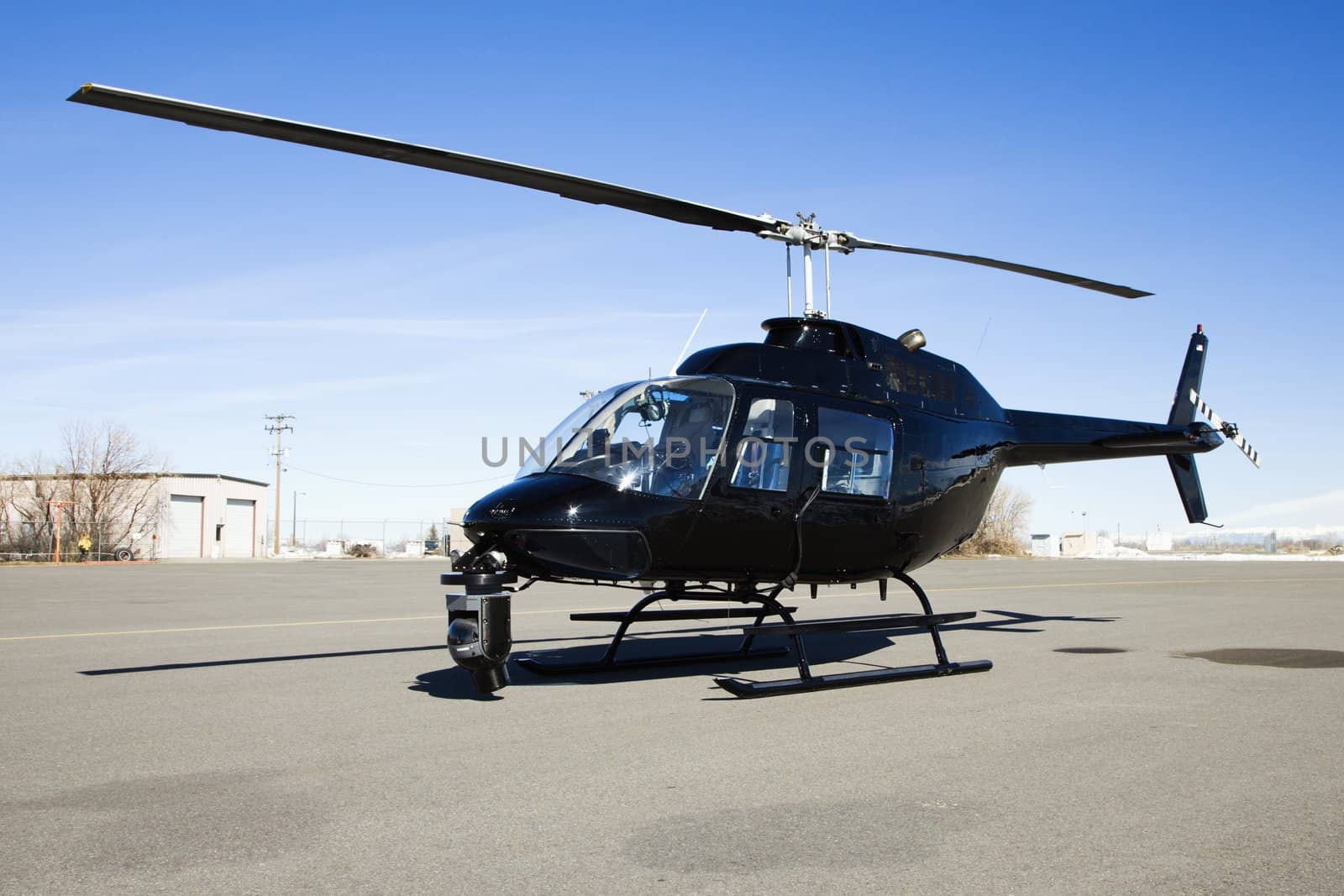 Helicopter parked at airport lot. by iofoto