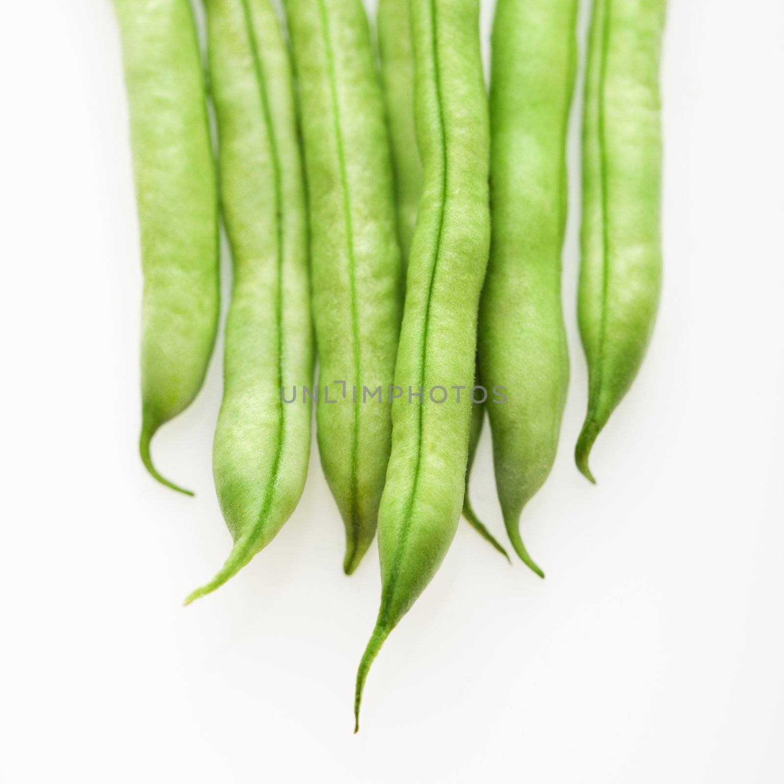 Close up of green beans on white background.