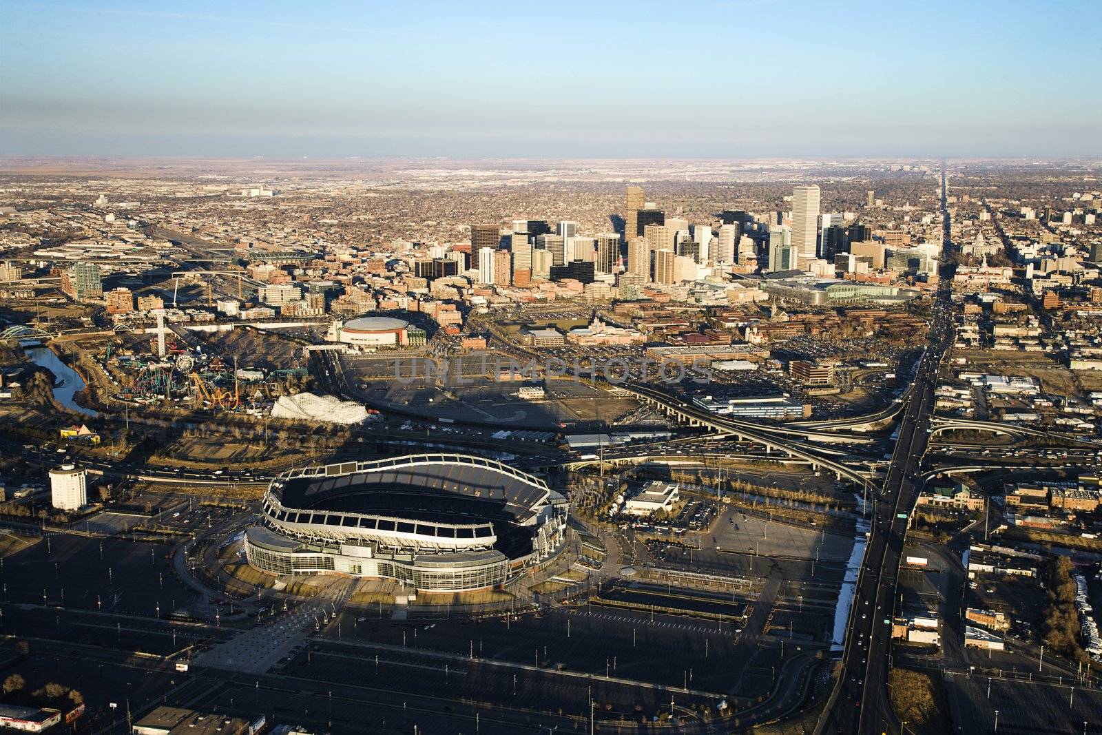 Aerial cityscape of urban Denver, Colorado, with Mile High stadium in foreground.