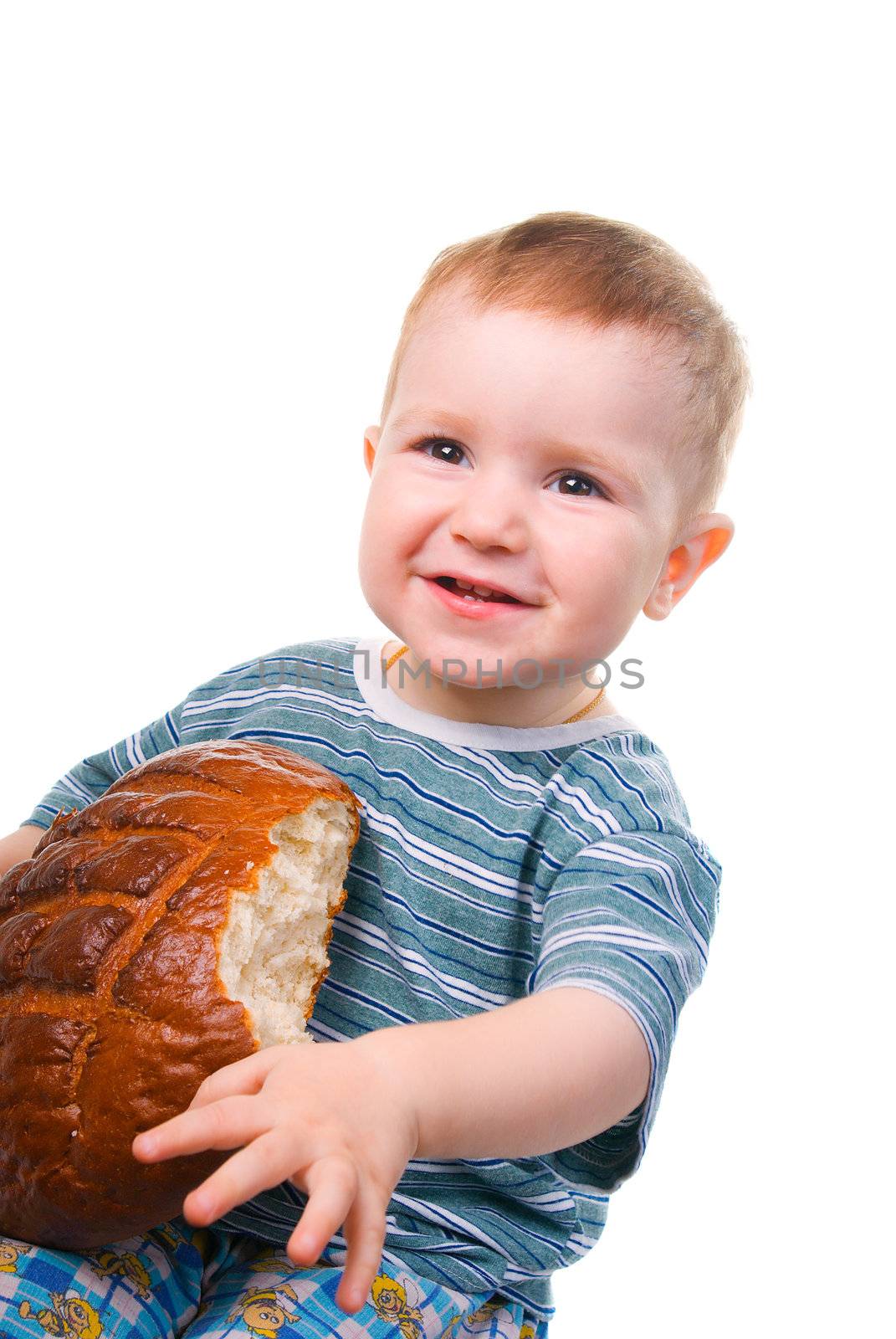 A little Caucasian boy eating a bread.isolated
on a white background.