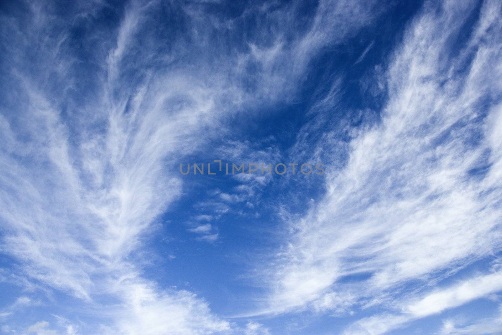 Blue sky with wispy clouds. by iofoto