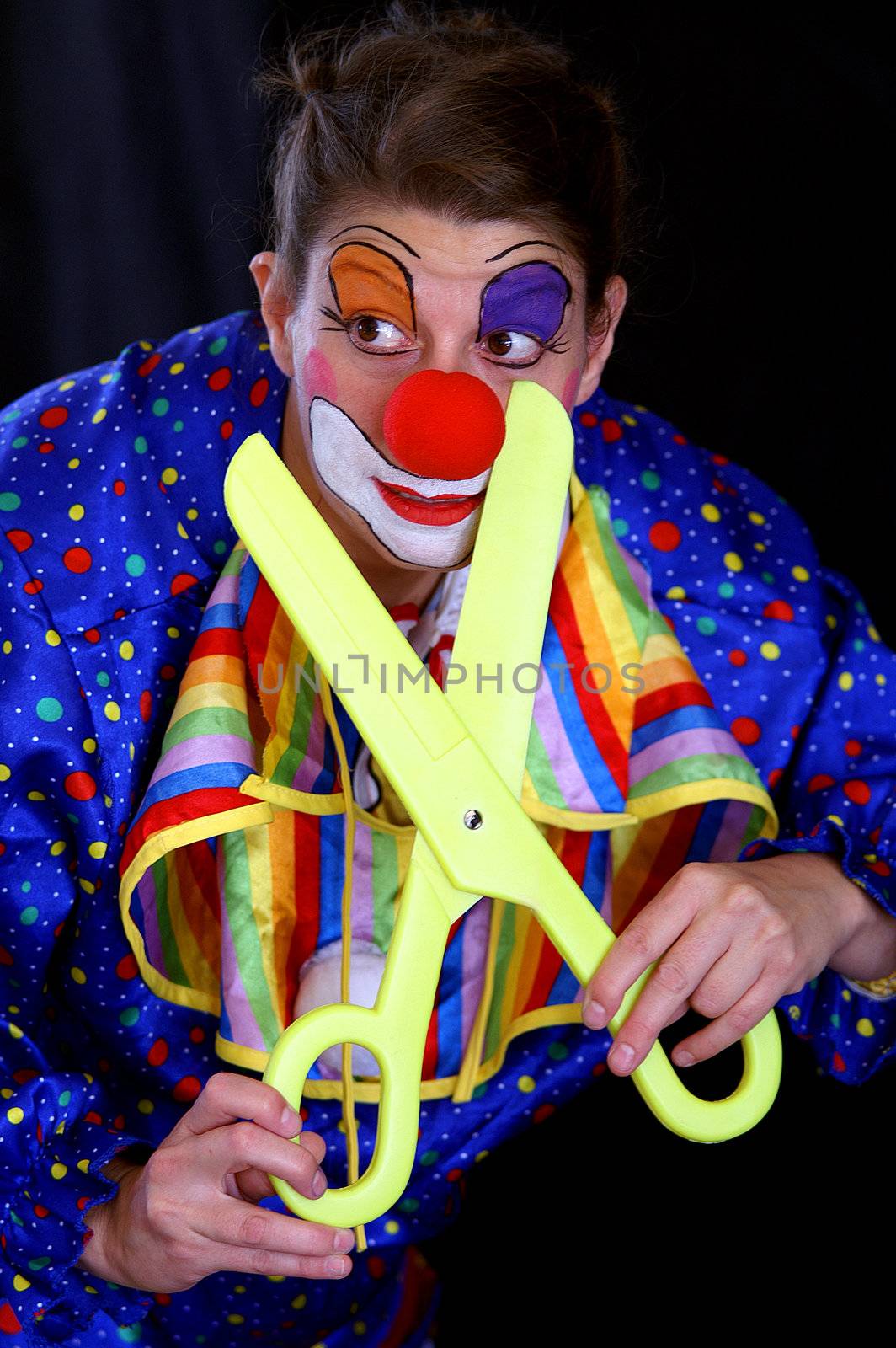 colorful clown with huge scissors