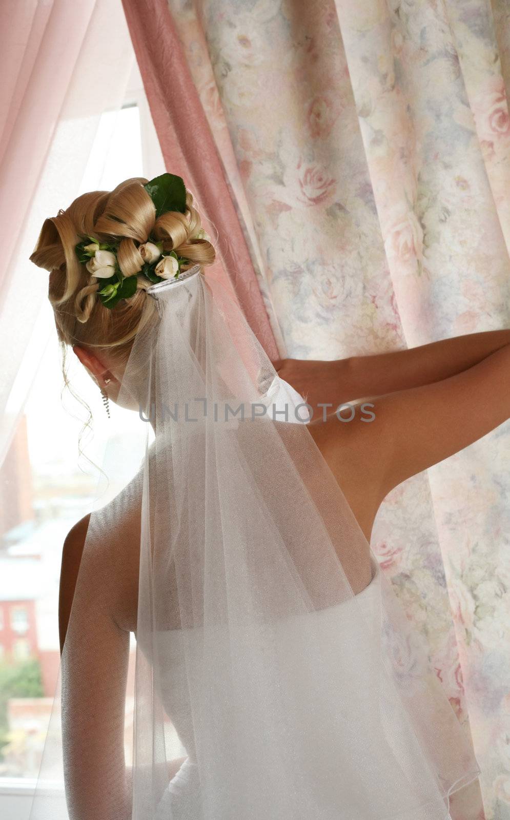 The bride at a window expects the groom