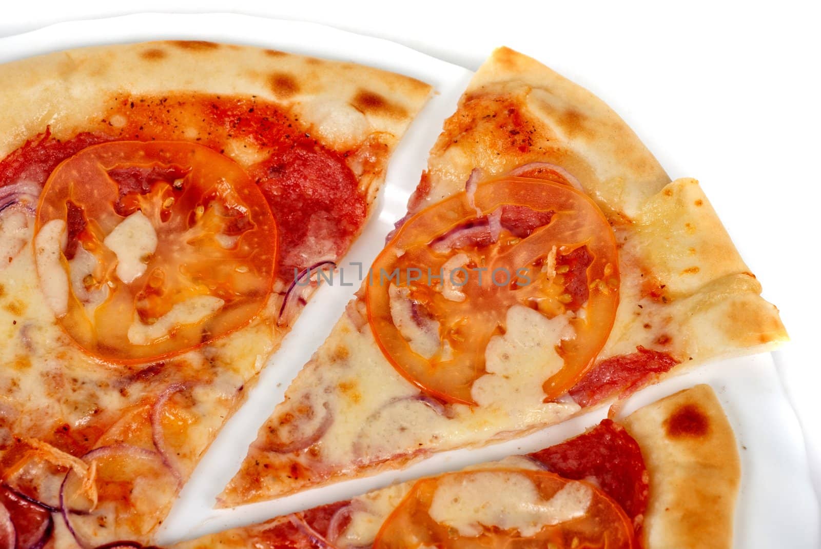 pizza closeup with salami, tomato, onion and mozzarella cheese