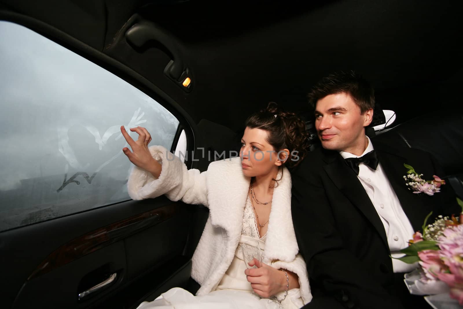 The bride and groom in automobile