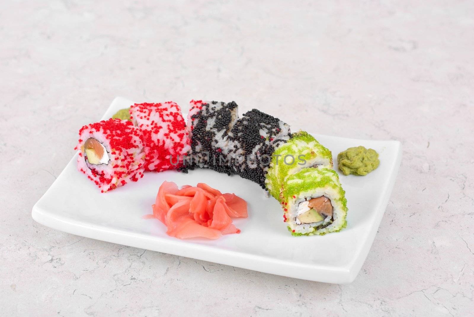 Sushi rolls made of salmon, avocado, flying fish roe - tobiko caviar and philadelphia cheese