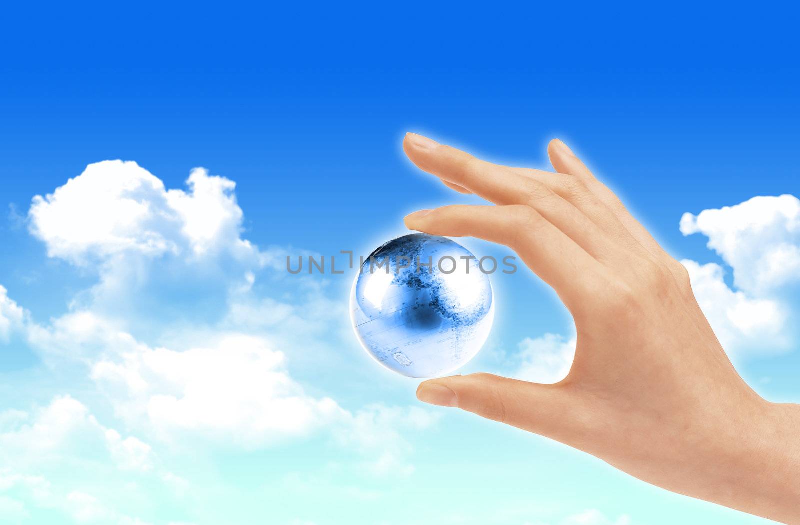 Eco concept : Hand hold globe  against   and the blue sky  by rufous