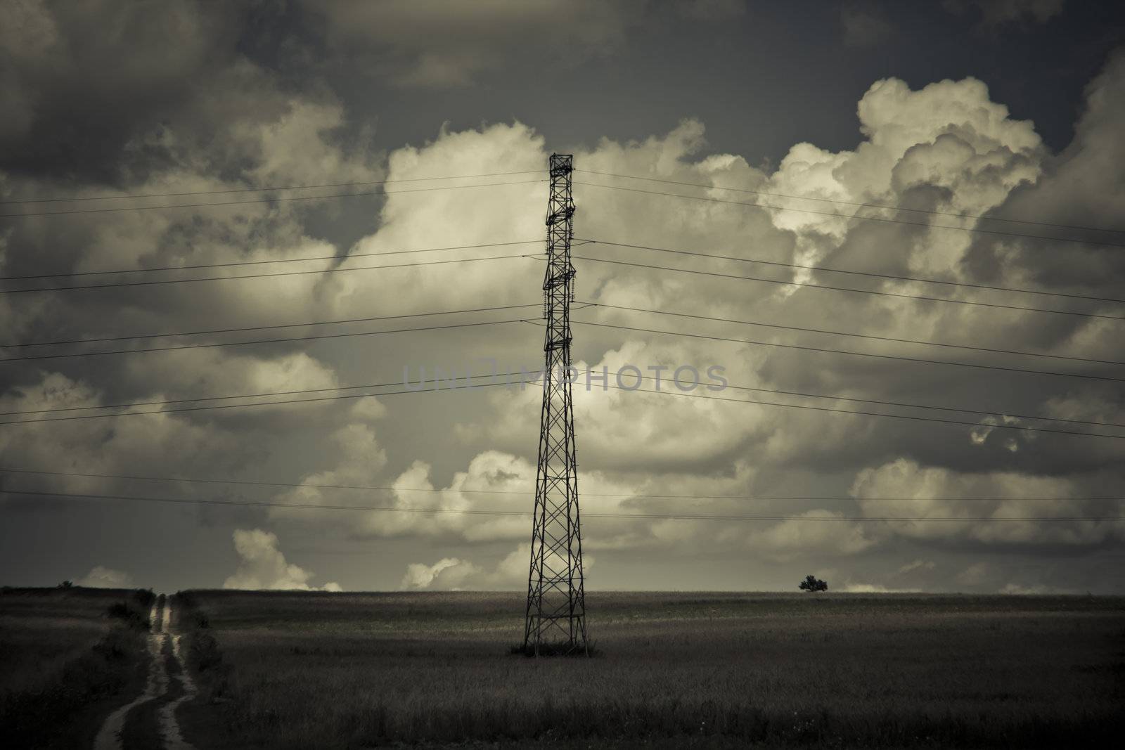 landscape with high tension wires over sky