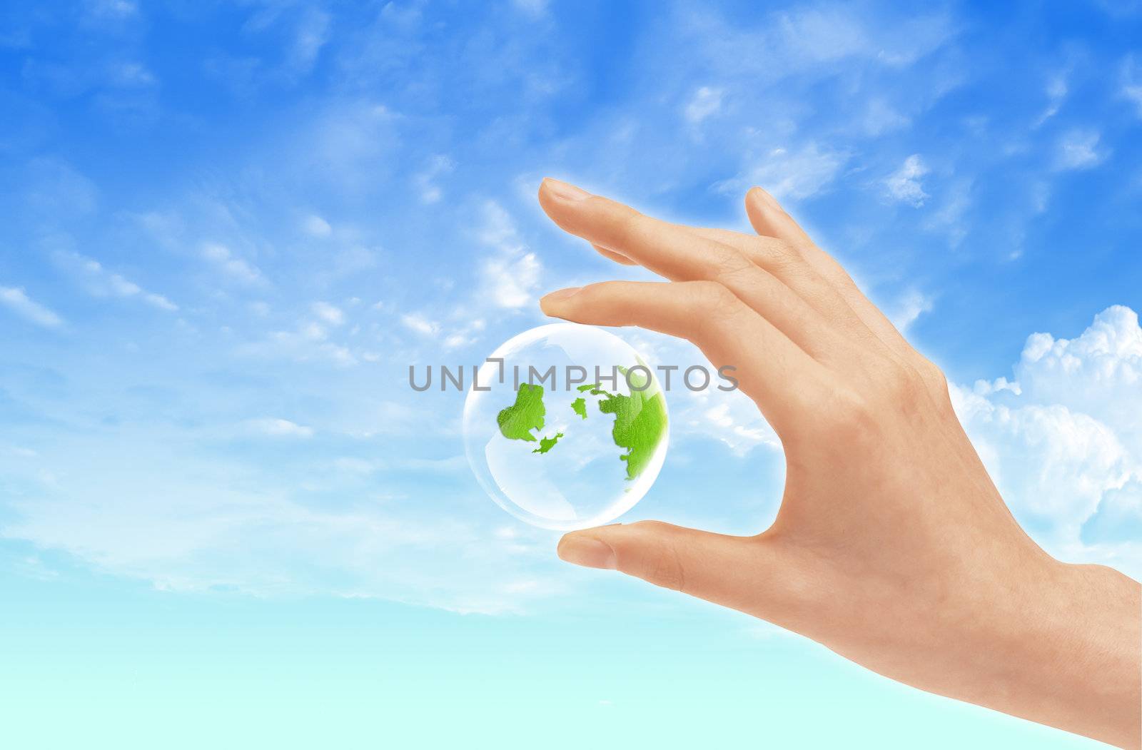 Eco concept : Hand hold globe  against   and the blue sky