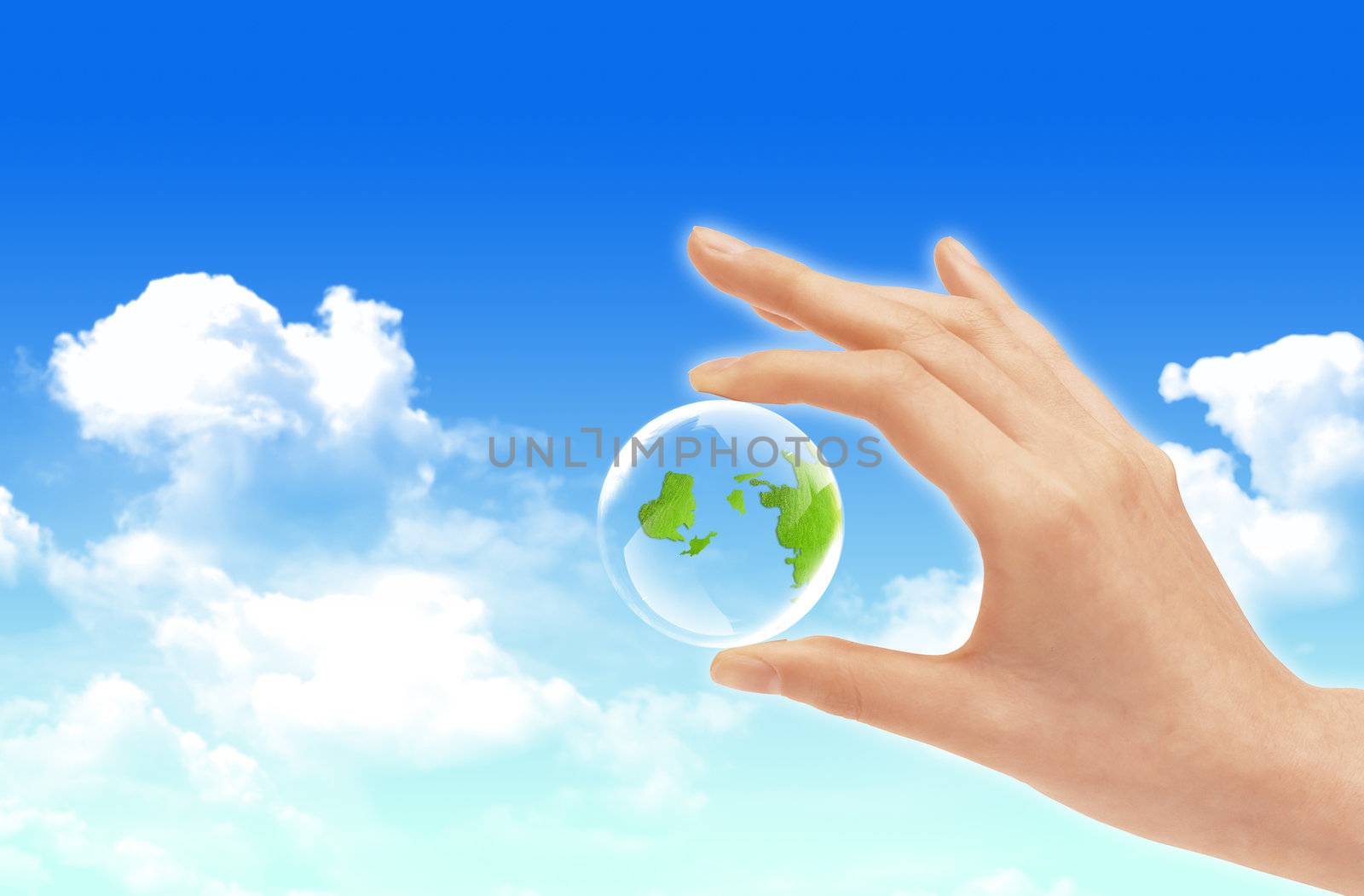 Eco concept : Hand hold globe  against   and the blue sky