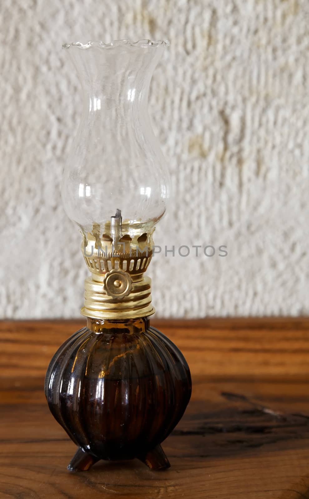 ornamental oil lantern on a side board with limestone background