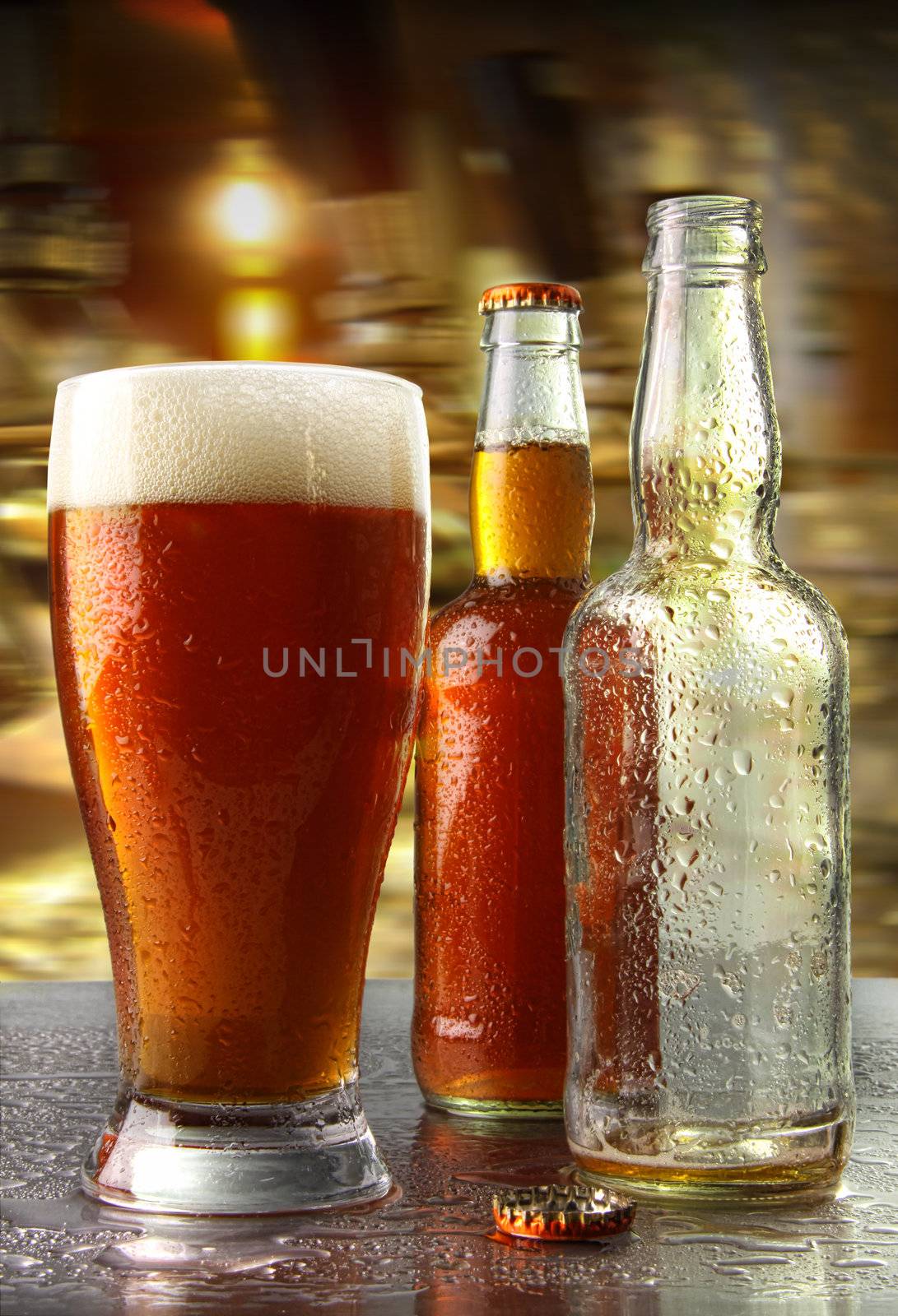 Glass of beer with bottles on counter