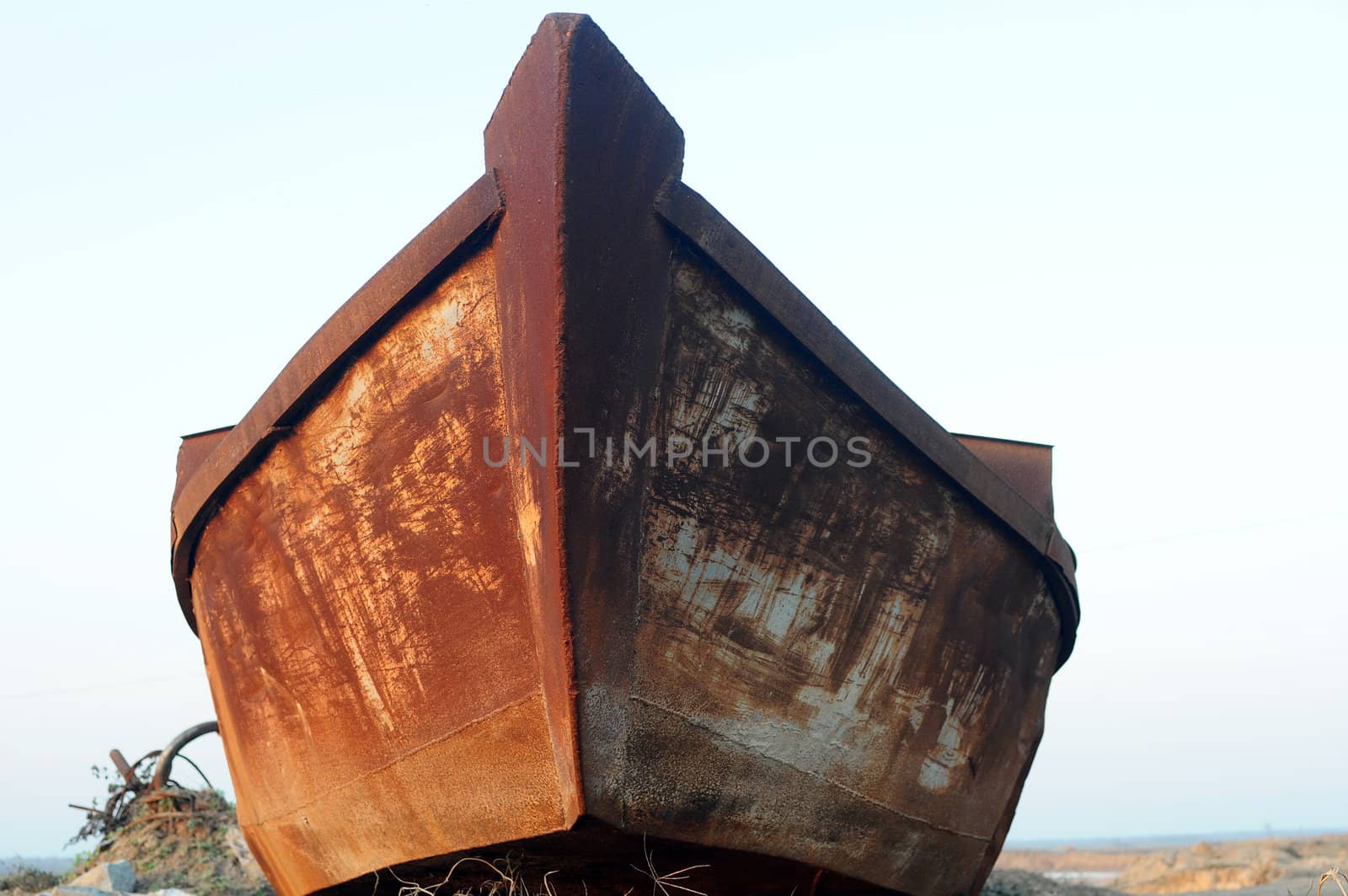 Old iron boat parked at riverside