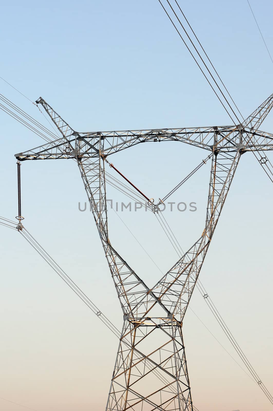 High voltage transmission lines with blue sky as background