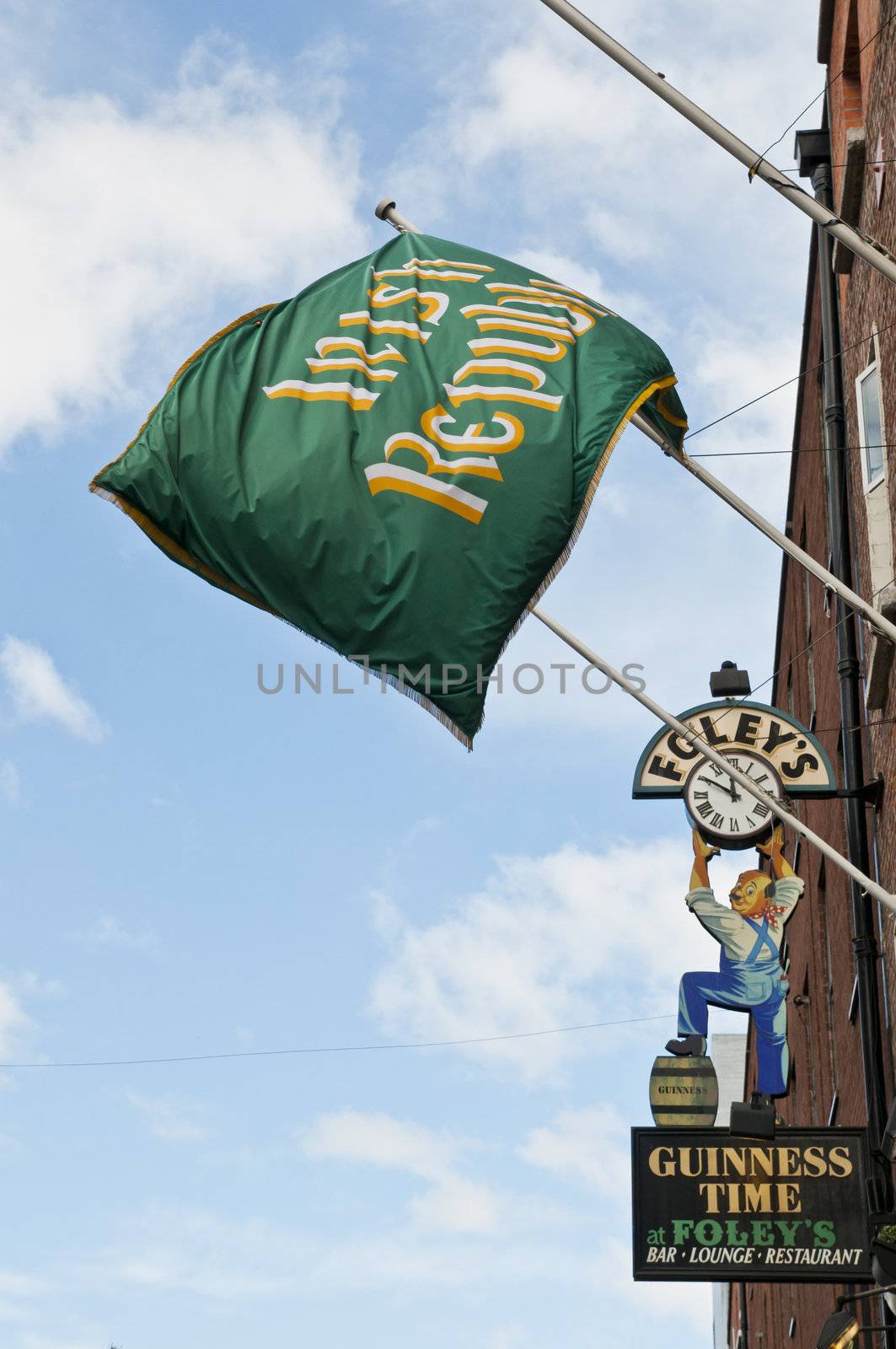 Flag of the Irish Republic hotel with Guinness pub sign in the background